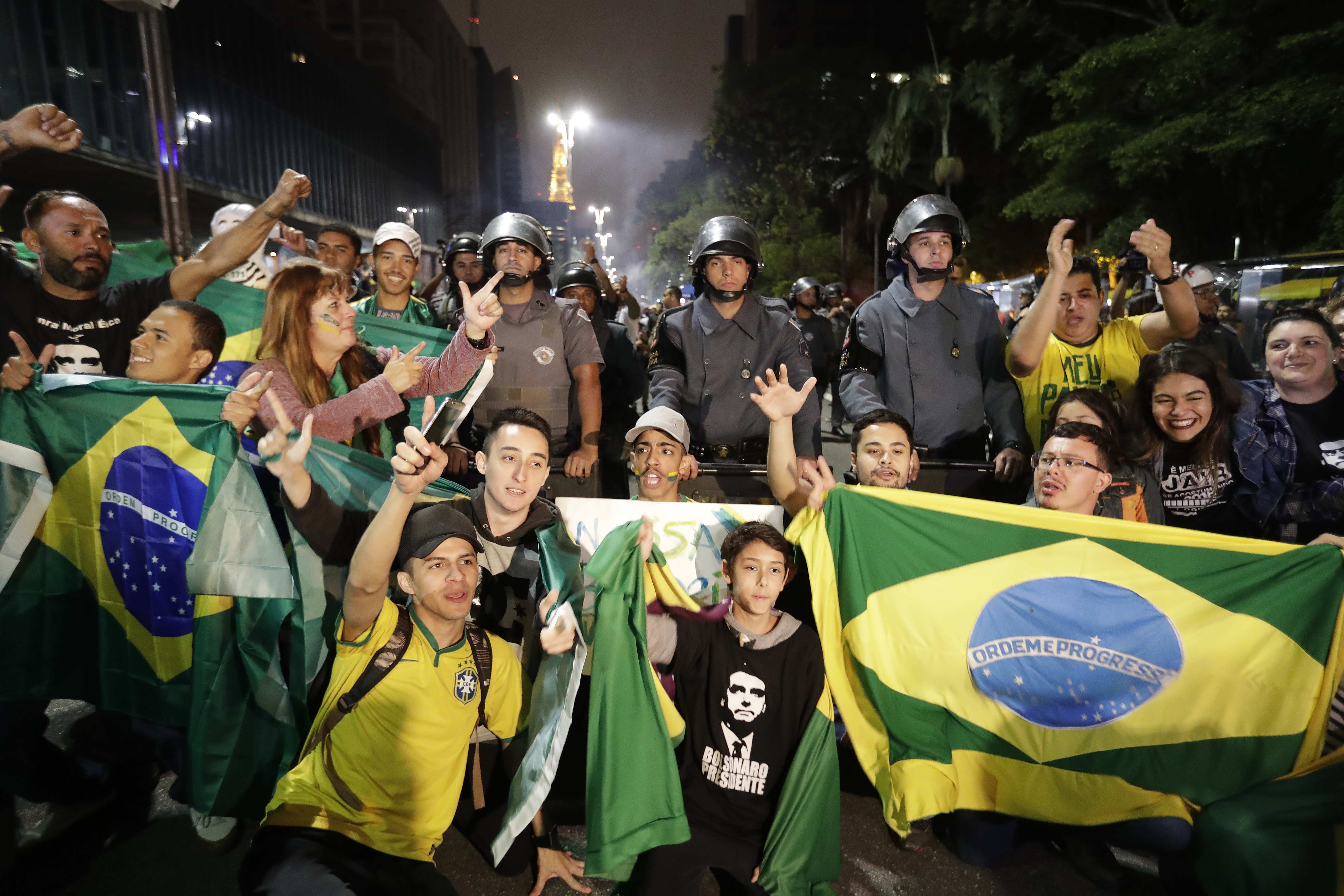 Supporters of ultrarightist Brazilian presidential candidate Jair Bolsonaro, who handily won the run-off election on Oct. 28, 2018, take photos as they celebrate his victory in Sao Paulo. EFE-EPA/Sebastião Moreira