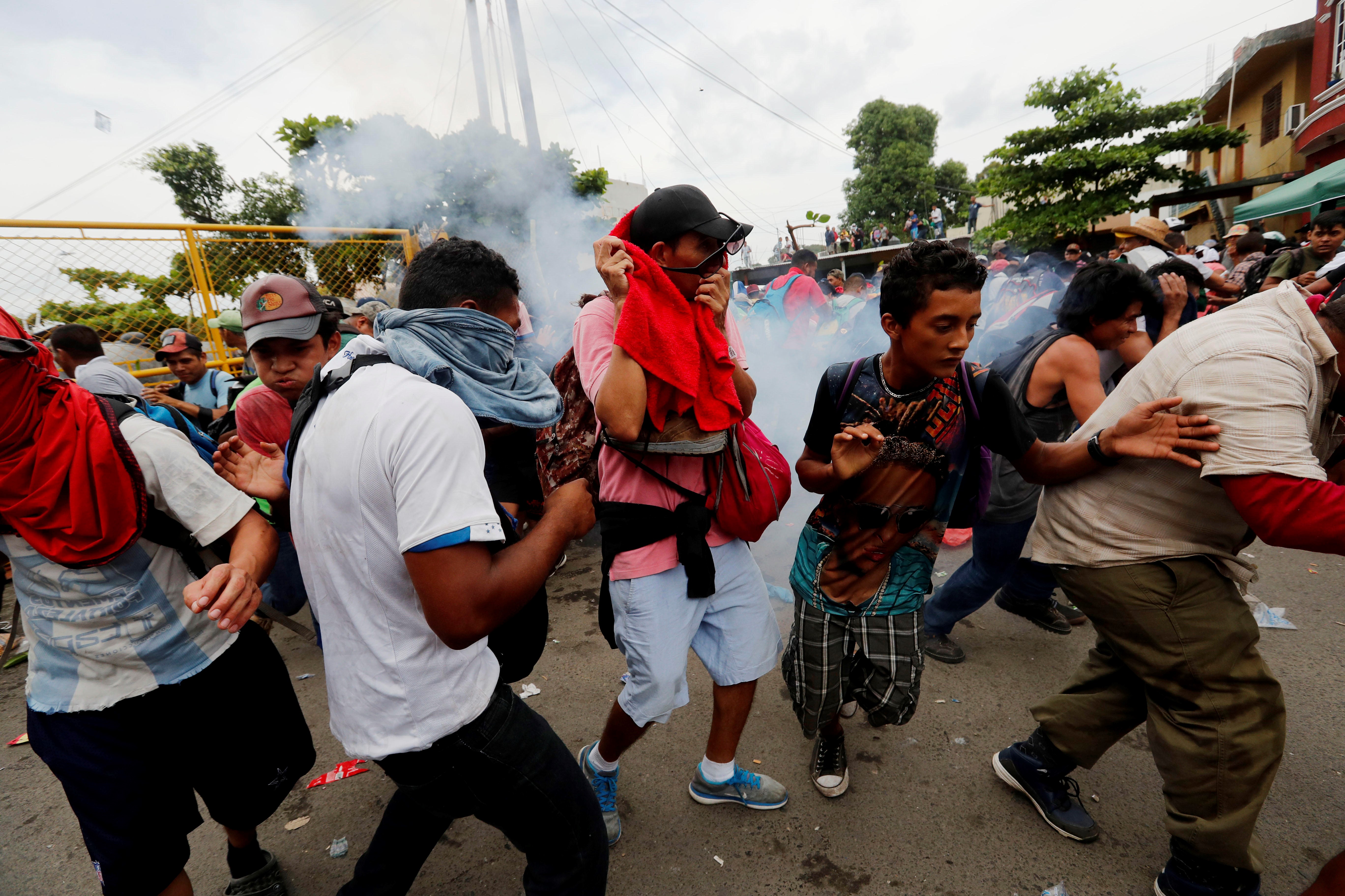 Honduran migrants clash with Guatemalan police on Oct. 28, 2018, in the border town of Tecun Uman before breaking through a metal fence at the border with Mexico and entering Mexican territory. EFE-EPA/ESTEBAN BIBA