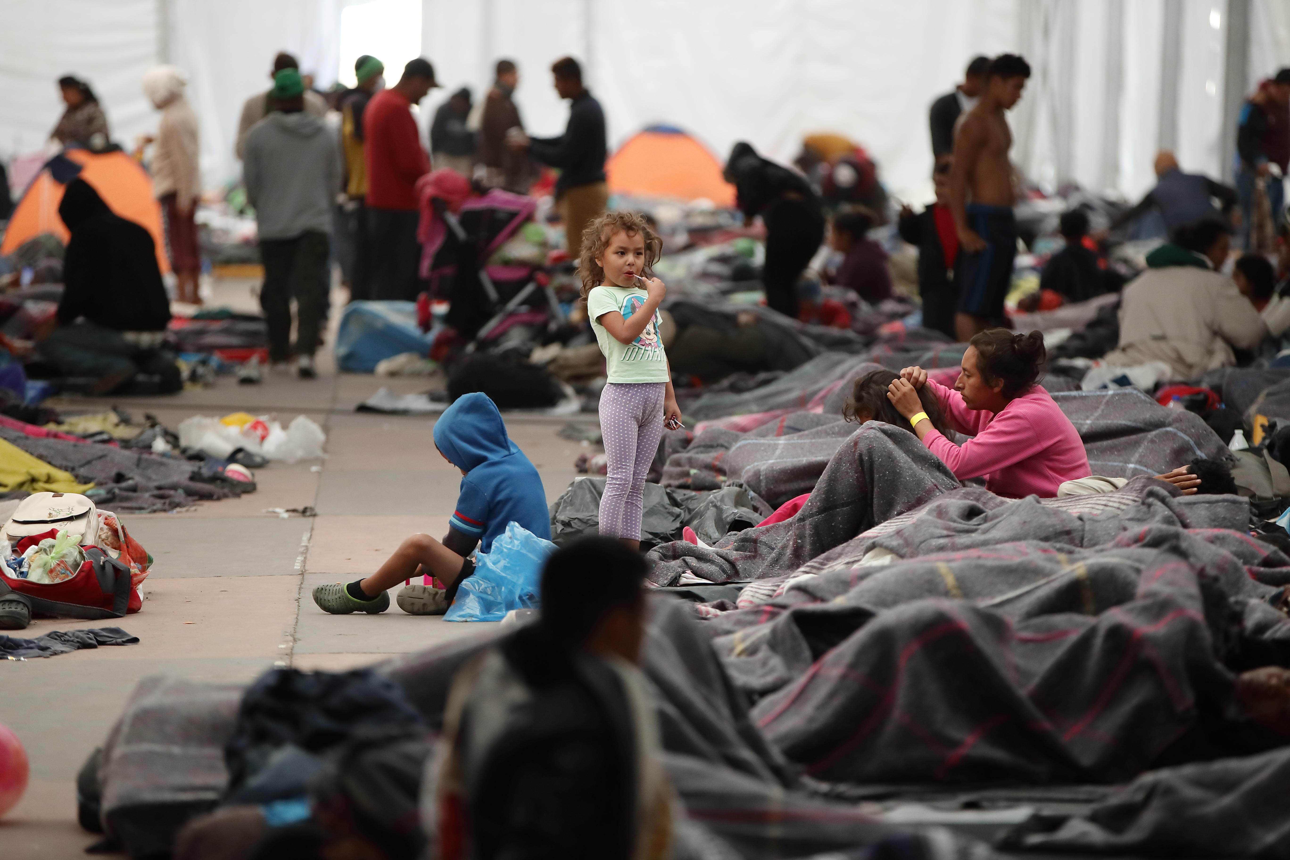 Migrants rest in a shelter set up at a soccer stadium in Mexico City on Nov. 6, 2018, the day Mexico's National Human Rights Commission (CNDH) reports that roughly 80 people who entered the country with the caravan of Central American migrants bound for the United States have gone missing.  EFE-EPA/Jose Mendez
