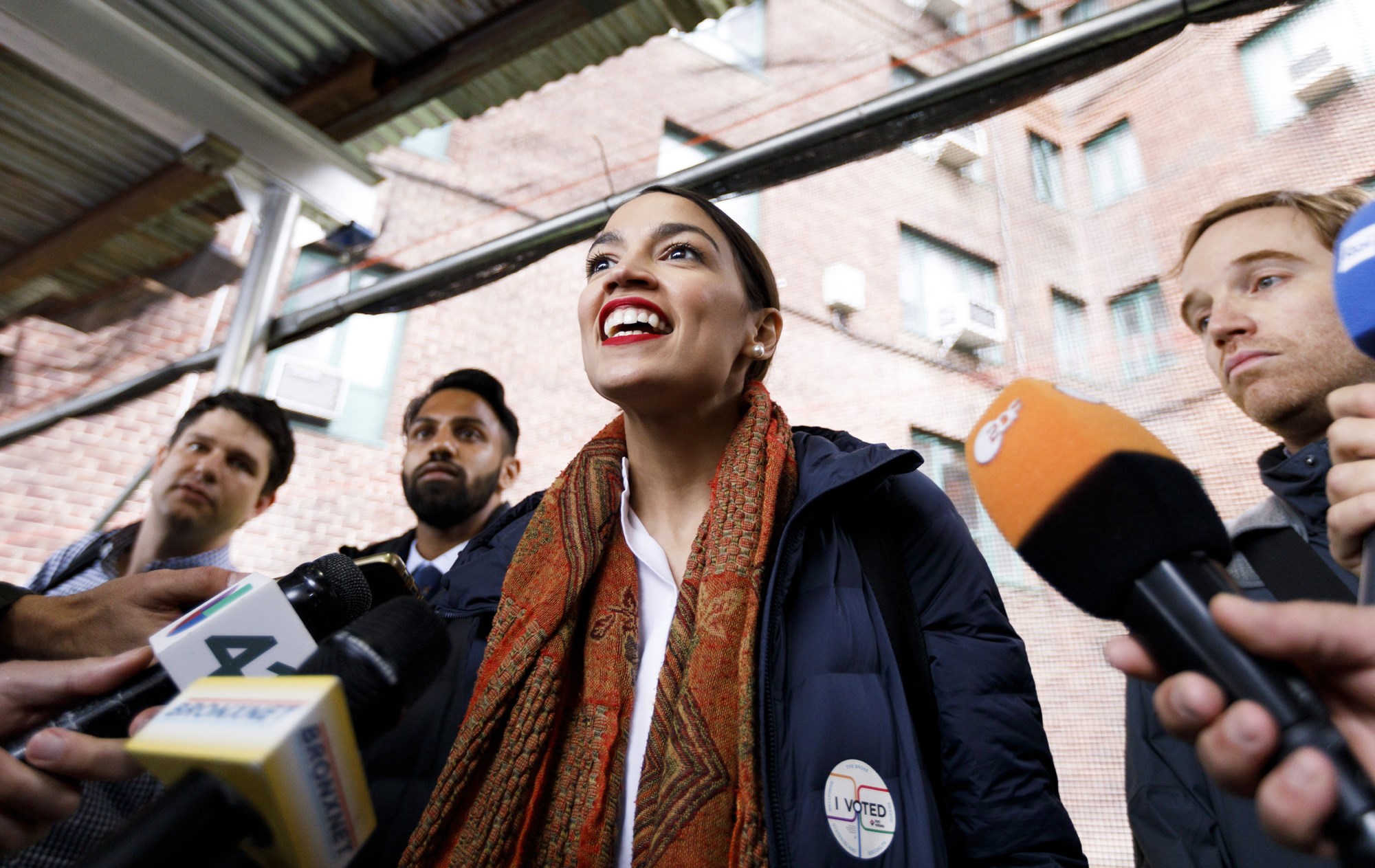 Alexandria Ocasio-Cortez (C), who is running as the Democratic nominee for New York's 14th congressional district, talks with reporters after casting her ballot in the 2018 midterm general election at a polling site in the Bronx, New York, USA, Nov. 6, 2018. EPA-EFE/JUSTIN LANE