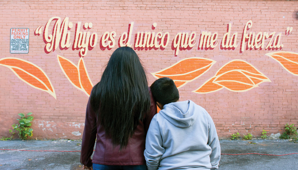 Delmy and her son, both detained at Berks County Detention Center for nearly two years, look at the mural with Delmy’s words written above. Photo: Osmyn Oree