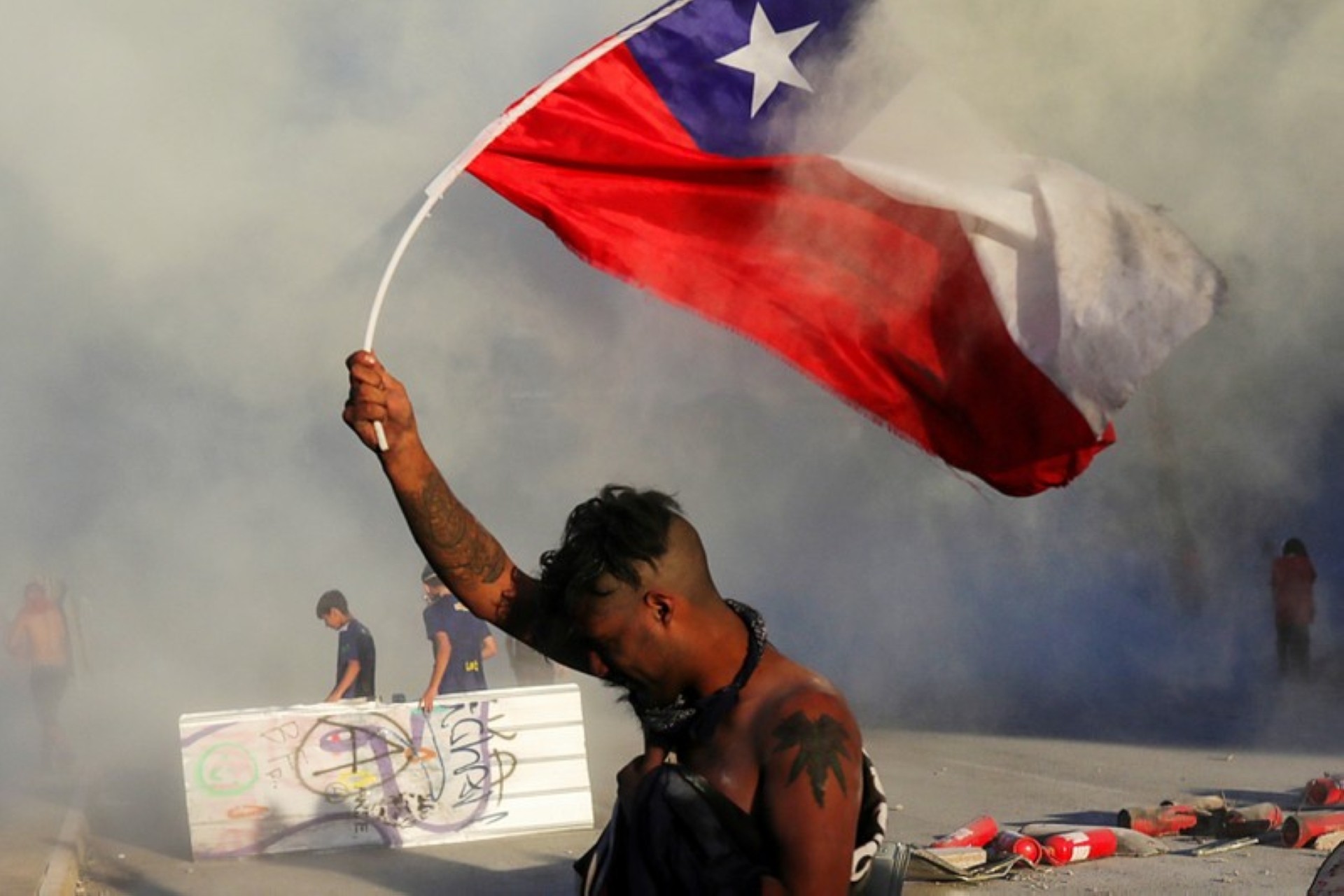 A demonstrator holds a Chilean flag during a protest. November 9. REUTERS/Pablo Sanhueza Taken from thestar.com