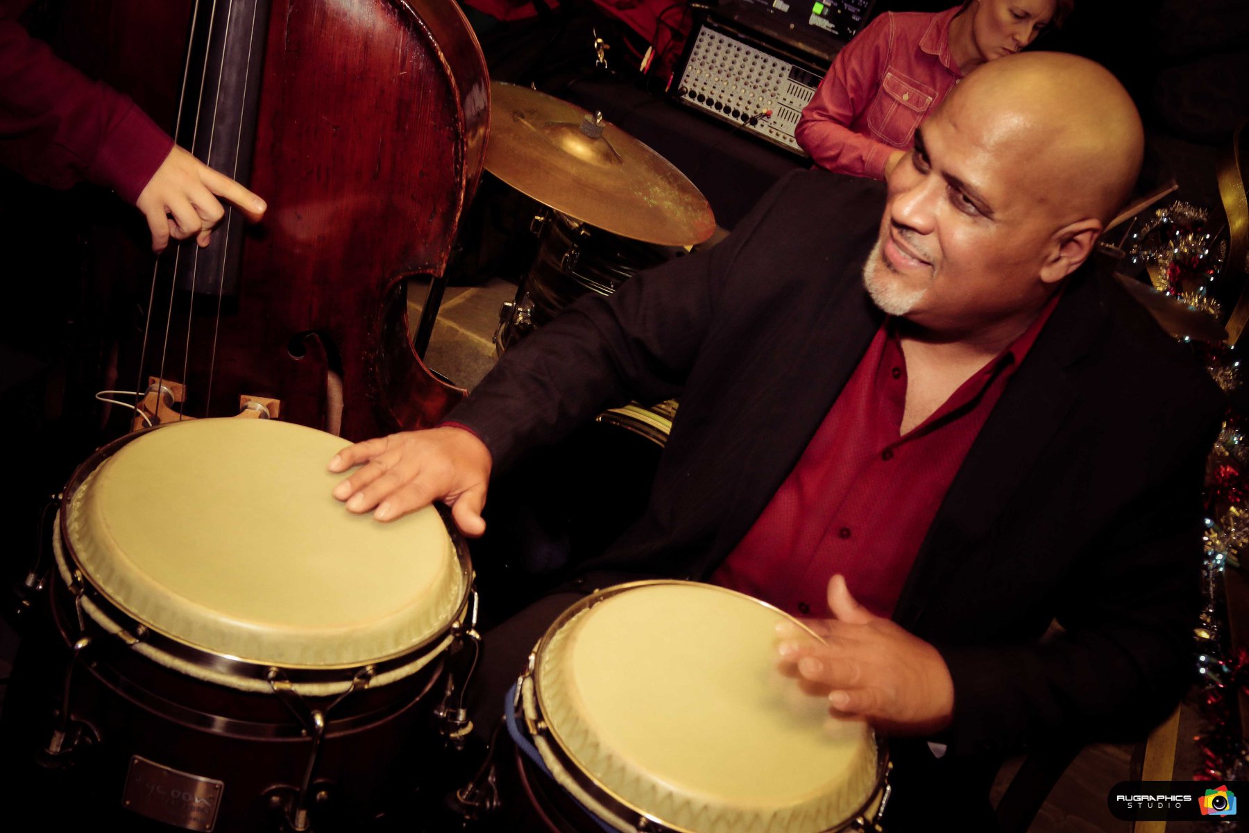 “Mr. Conga” Noël Quintana smiles while playing the conga. Photo Courtesy of Noel Quintana's Latin Crew Facebook. 