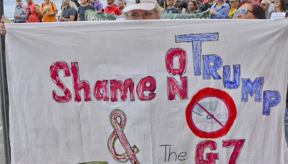 A demonstrator holds a protest banner, during the 'No G7' protest march at the G7 summit in Giardini Naxos, near Taormina, Sicily island, Italy, 27 May 2017. Heads of States and Governments of the G7, the group of most industrialized economies, plus the European Union, meet in Taormina, Italy, from 26 to 27 May 2017 for a summit titled 'Building the Foundations of Renewed Trust'. EFE/EPA/CIRO FUSCO
