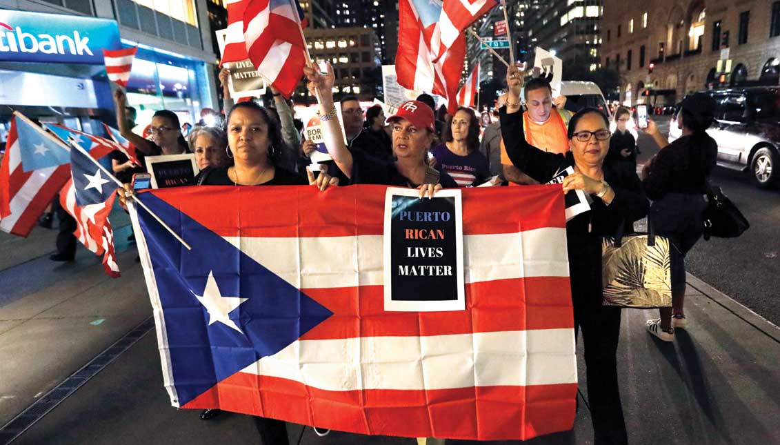 Hundreds of people protest near Trump Tower after a service for the victims of Hurricane Maria on Thursday, September 20, at the Church of St. Bartholomew in New York. EFE