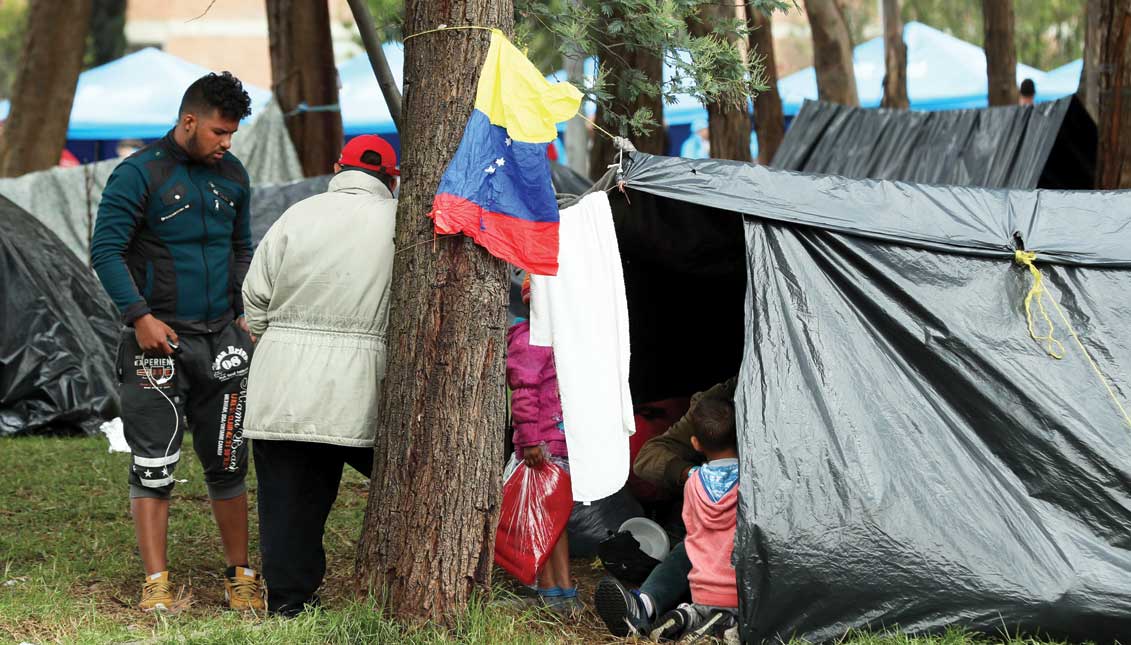 Venezuelan migrants seek shelter and remain in an improvised camp near a bus terminal in Bogota, Colombia. EFE
