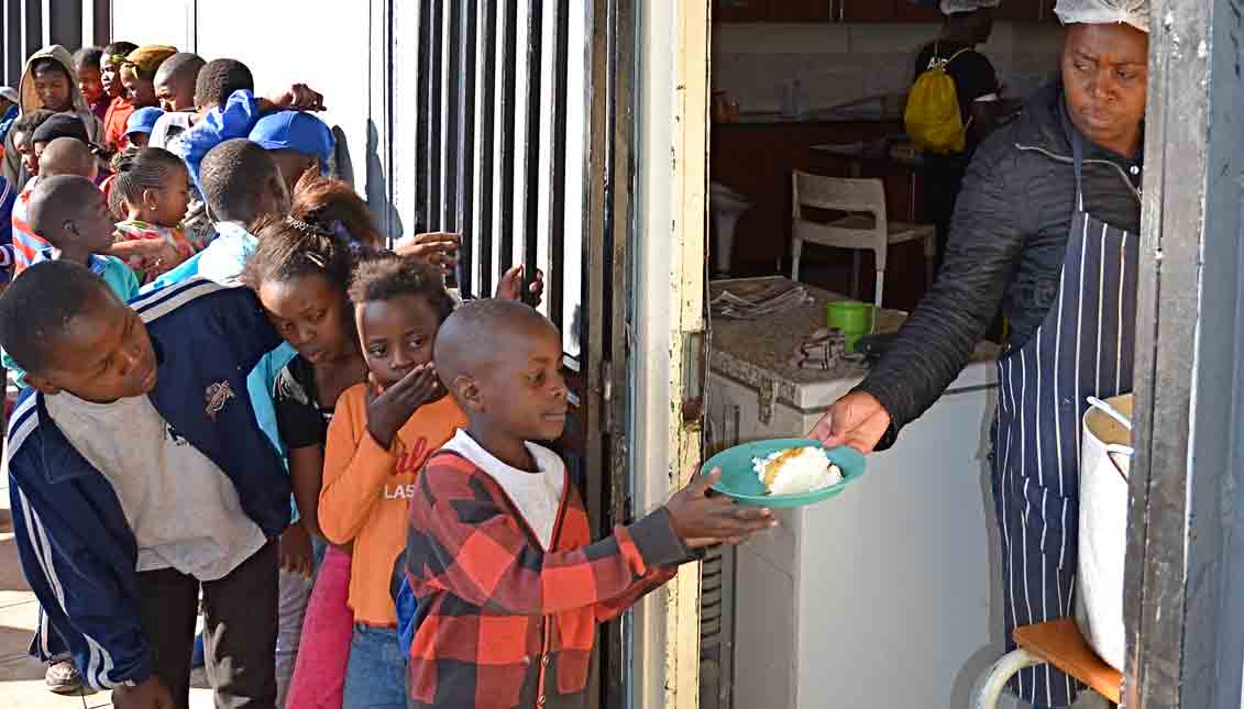 Children in the ultra-impoverished community of Kliptown outside Johannesburg, South Africa receive after-school meals funded by donations. LBWPhoto
