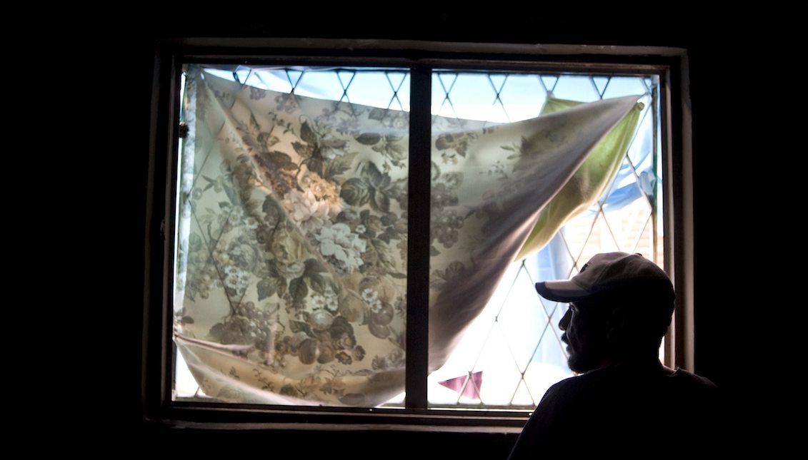 A Mexican man who was deported from the United States several years ago looks from a window at a shelter for the homeless in Tijuana, Mexico, on April 5, 2013. EPA/DAVID MAUNG