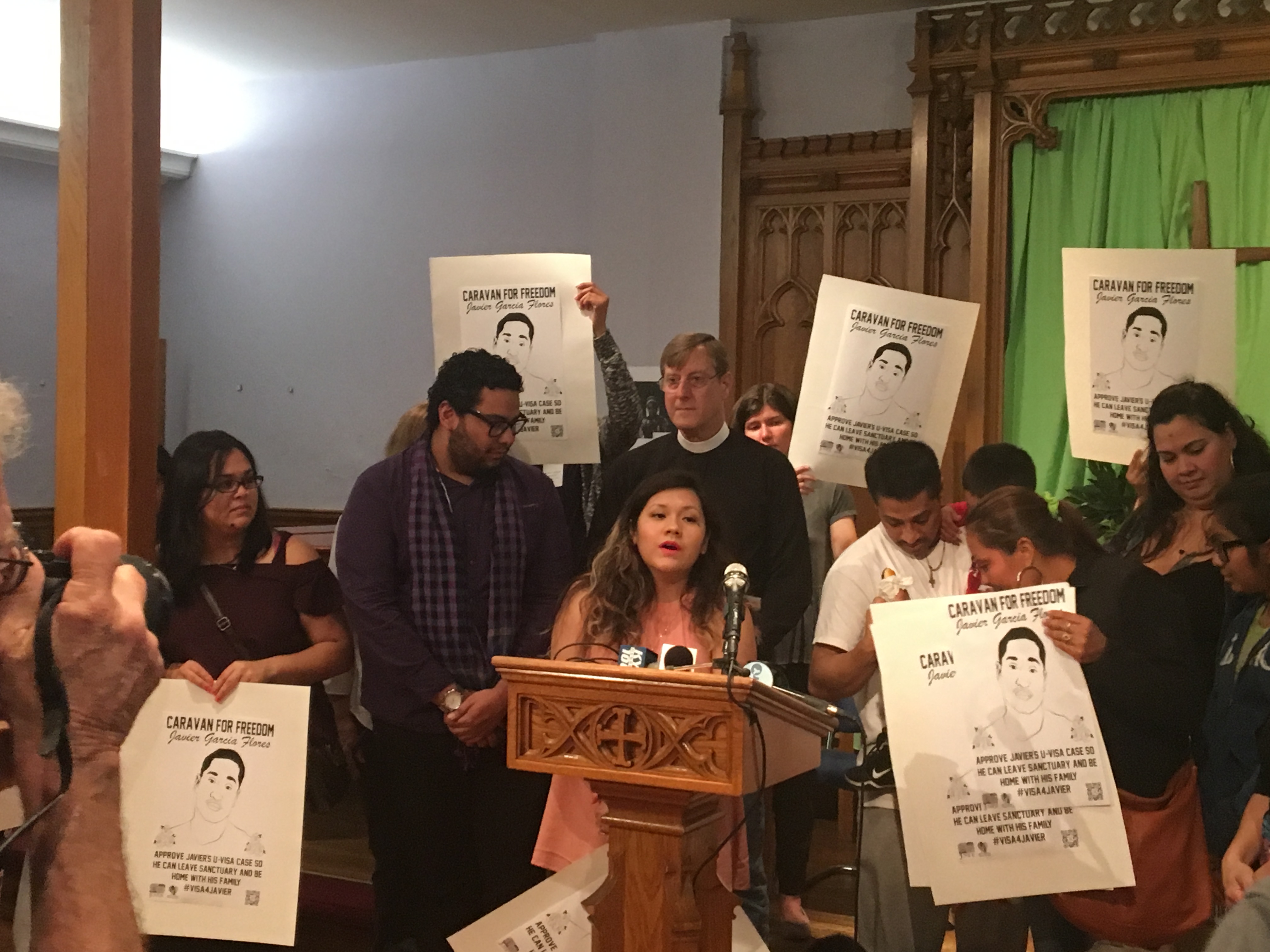 Olivia Vazquez translates a statement from Javier Flora, the man staying at Arch St. Methodist Church, after a deportation order from ICE officials.
