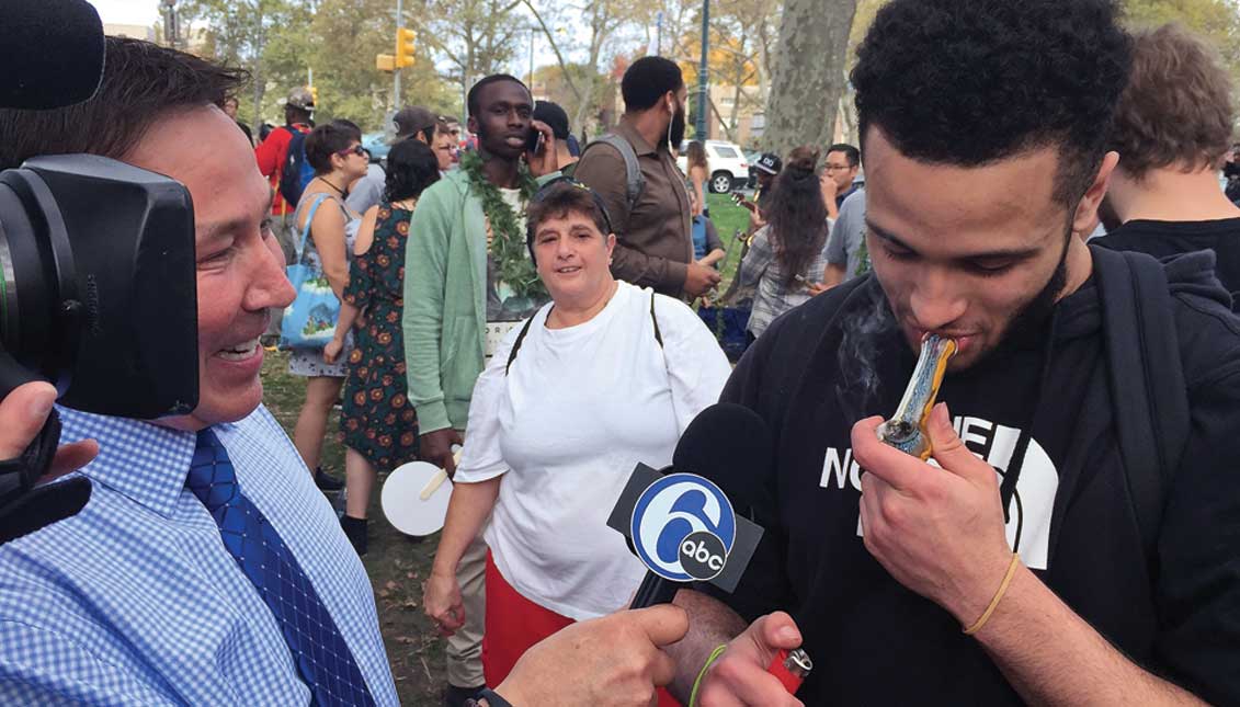 Man enjoying marijuana during a celebration across from Philadelphia's famed Art Museum last October commemorating the second anniversary of decriminalization of marijuana possession in Philadelphia. Decrim has saved the City millions in costs for arrest and adjudication of pot. LBWPhoto.
