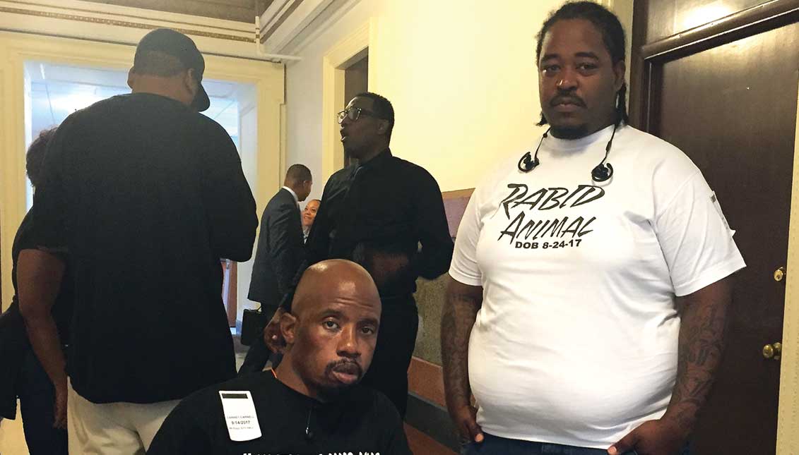 Paralyzed 2010 police abuse victim Carnell Williams-Carney (left) and Anthony Jones (right), brother David Jones who was fatally shot in June. Williams-Carney and David Jones where each shot in the back by the same policeman, Ryan Pownall, who was recently suspended by the Police Department with intent to dismiss. LBWPhoto.
