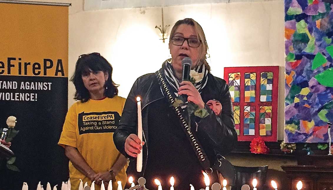 Aleida Garcia (with candle) wearing photo of her murdered son during "Vigil For Victims Of Gun Violence." LBWPhoto