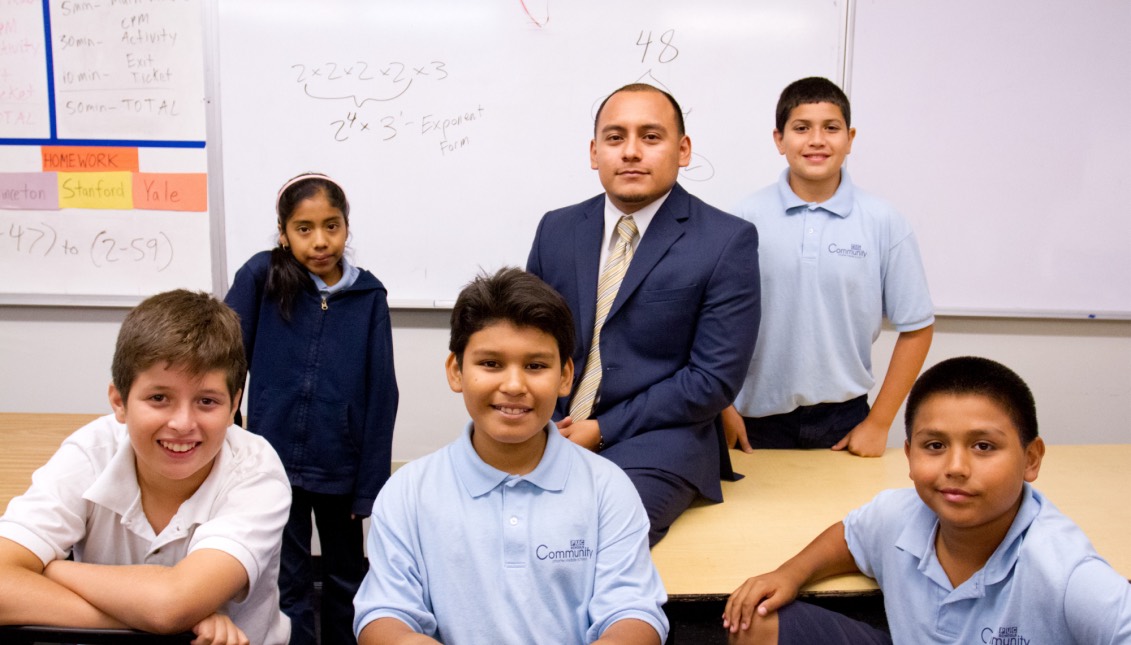 Roque Pech (center), a DACA beneficiary, poses with the sixth-graders from PUC Community Charter in Lakeview Terrace, California