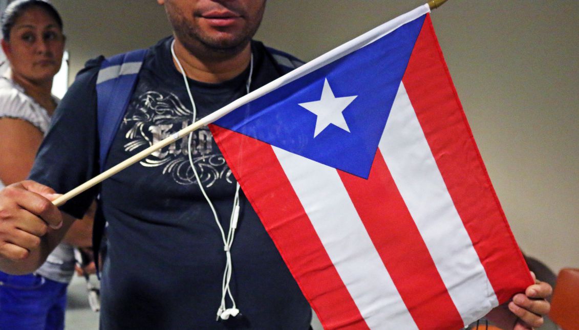 Vladimir Rivera holds a small Puerto Rico that he brought to the Press Conference on Thursday, September 21st, or Unidos PA’ PR. Rivera is a native of Puerto Rico and has not been able to make contact with his family back home, including His mother, brother and daughter in San Juan. Photo: Matthew Haubenstein