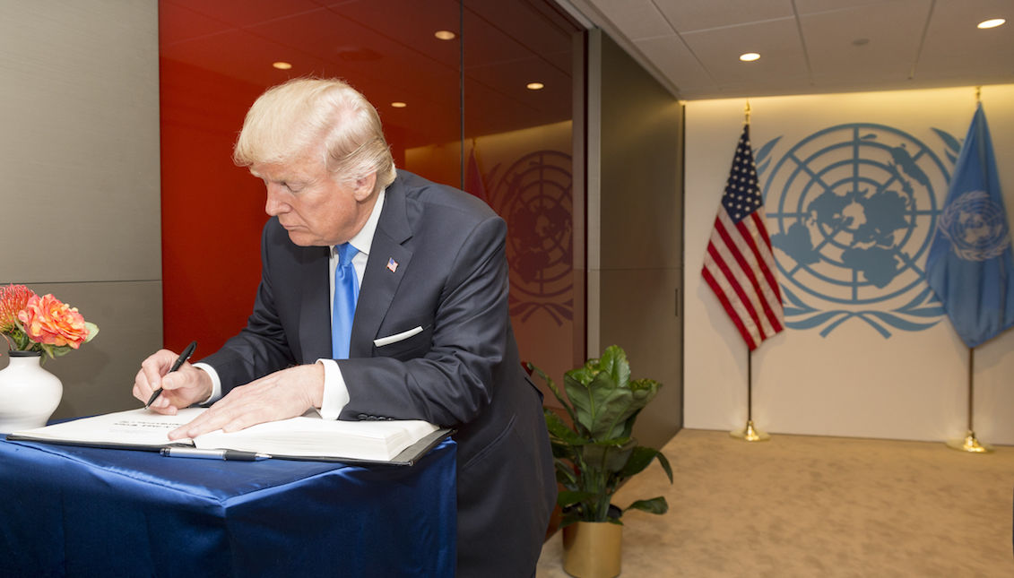 Photo courtesy of the UN, where the US President Donald Trump is signing the United Nations guest book on Tuesday, September 19, 2017, after a meeting with its secretary general at the agency's headquarters in New York. EFE / Rick Bajornas / UN