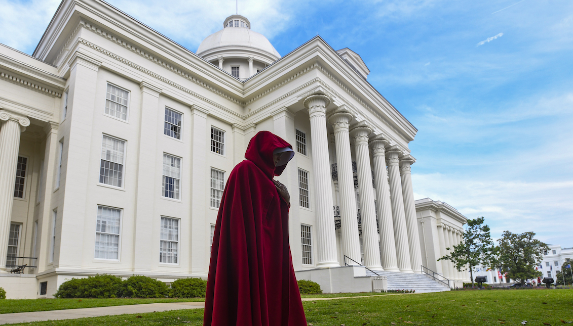 MONTGOMERY, AL - MAY 19: A protestor dressed as a character from the Hulu TV show "The Handmaid's Tale," based on the best-selling novel by Margaret Atwood, walks back to her car after participating in a rally against one of the nation's most restrictive bans on abortions on May 19, 2019 in Montgomery, Alabama. (Photo by Julie Bennett/Getty Images)