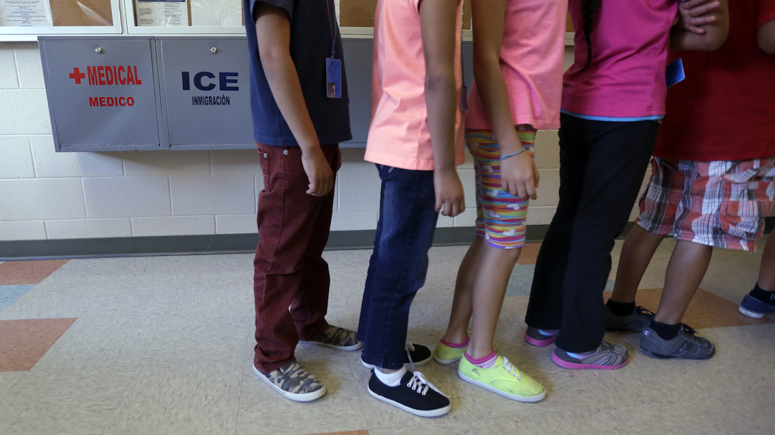 Detained immigrant children line up in the cafeteria at the Karnes County Residential Center, a temporary home for immigrant women and children detained at the border. Eric Gay/AP