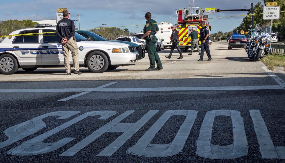 Several police officers guard Marjory Stoneman Douglas high school in the city of Parkland, Florida, USA, on February 15, 2018, where at least 17 people died in a new shooting, the eighteenth so far this year in educational centers of the country, in a massacre that is attributed to former student of Hispanic origin Nikolas Cruz. EFE / Cristobal Herrera