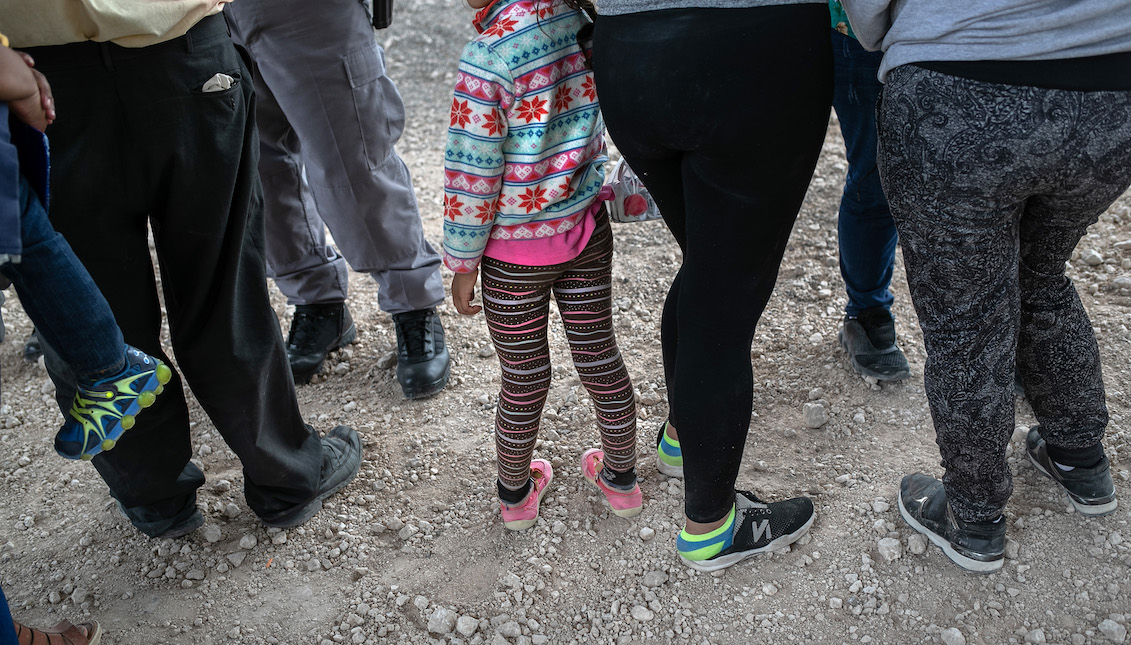 MCALLEN, TEXAS - JULY 02: Immigrants wait to be transported to a McAllen processing center after they were taken into custody by U.S. Border Patrol agents on July 02, 2019, in McAllen, Texas. The immigrants, mostly from Central America, had rafted across the Rio Grande from Mexico to seek political asylum in the United States. (Photo by John Moore/Getty Images)