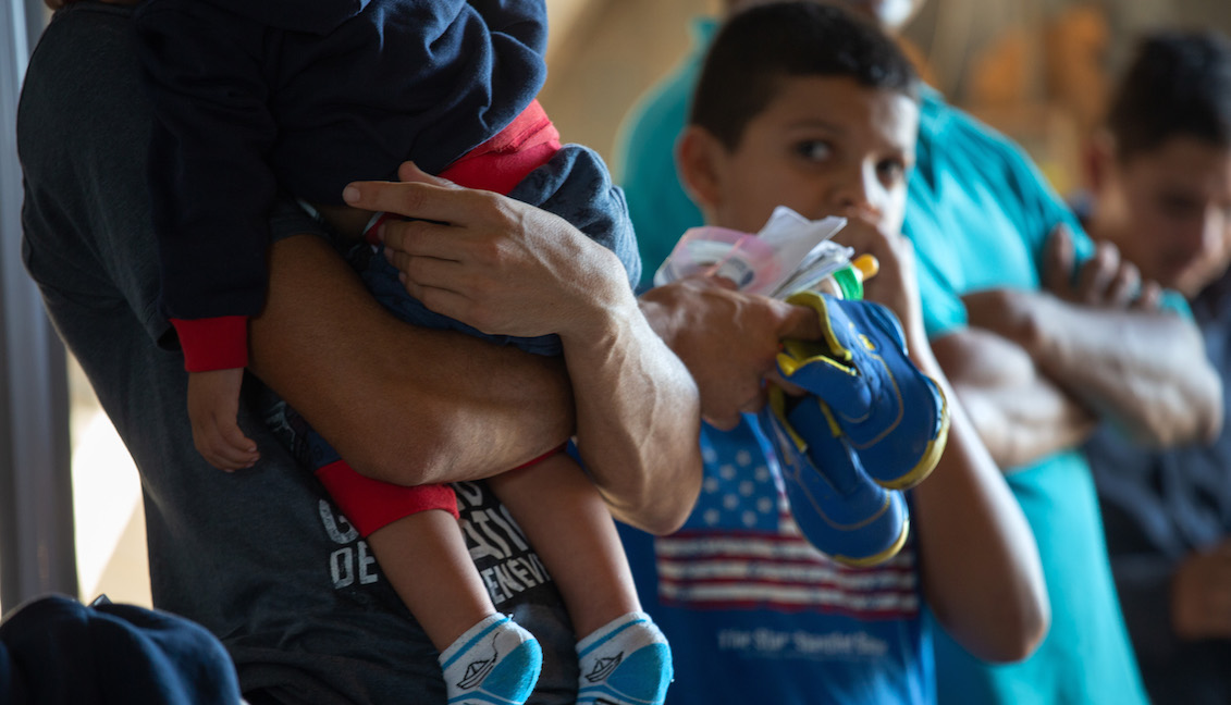 LOS EBANOS, TEXAS - SEPTEMBER 10: Families, mostly from Central America, wait to be transported to a U.S. Customs and Border Protection processing center after they crossed the Rio Grande from Mexico and presented themselves to border agents on September 10, 2019, in Los Ebanos, Texas. (Photo by John Moore/Getty Images)