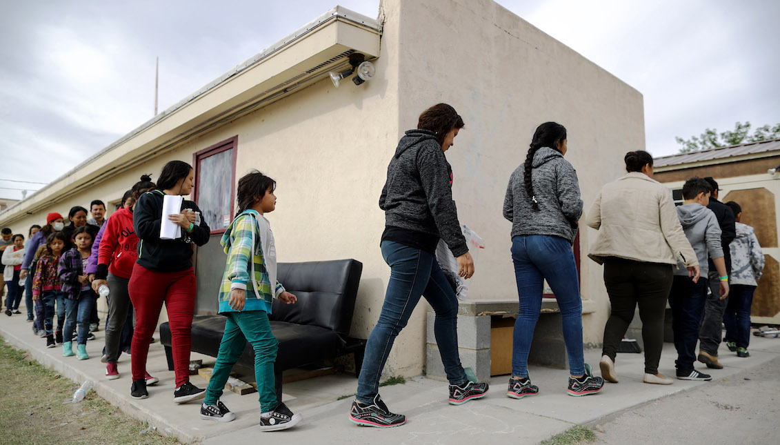 LAS CRUCES, NM - MAY 20: Asylum seekers walk in a line as they are dropped off by bus at a church shelter for migrants who are seeking asylum, after they were released by the U.S. Immigration and Customs Enforcement (ICE), on May 20, 2019 in Las Cruces, New Mexico. (Photo by Mario Tama/Getty Images)