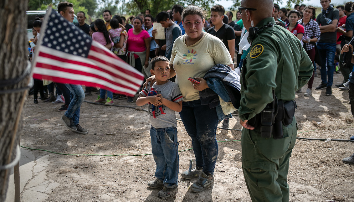 LOS EBANOS, TEXAS - JULY 02: A U.S. Border Patrol agent speaks to immigrants after taking them into custody on July 02, 2019 in Los Ebanos, Texas. (Photo by John Moore/Getty Images)