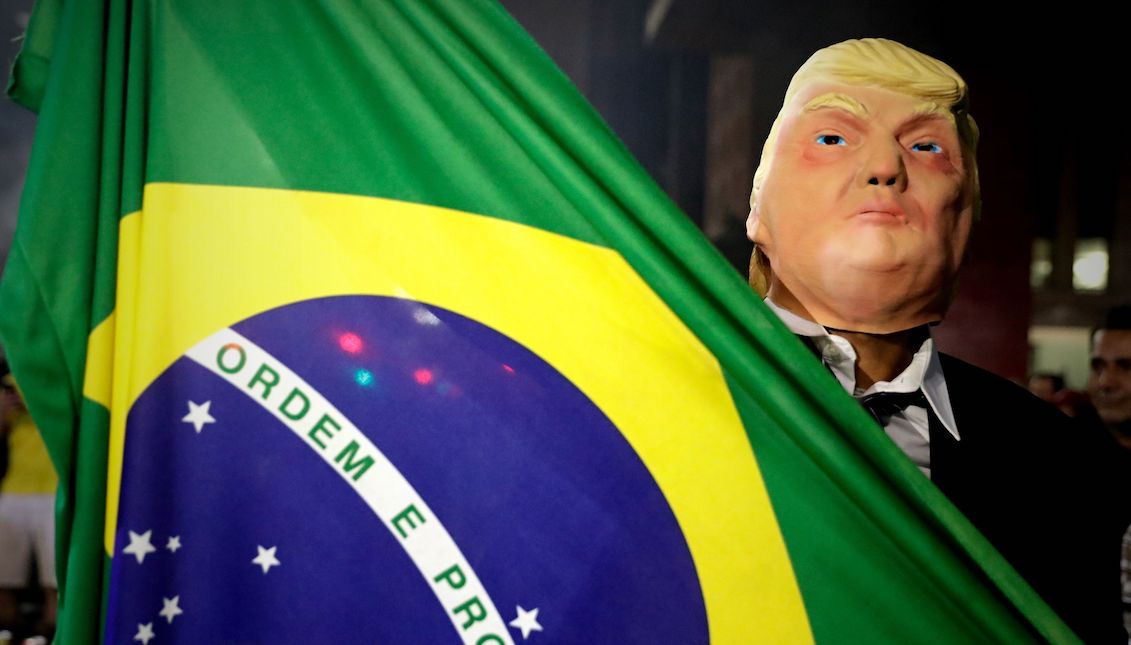 A sympathizer of Brazilian presidential candidate Jair Bolsonaro wears a mask of Donald Trump as he celebrates his victory on Sunday, October 28, 2018, on Avenida Paulista, in Sao Paulo (Brazil). The far right Jair Bolsonaro won the presidential elections in Brazil with 55.54% of the valid votes and will succeed the president Michel Temer on January 1, to govern the country until 2022. EFE/Fernando Bizerra