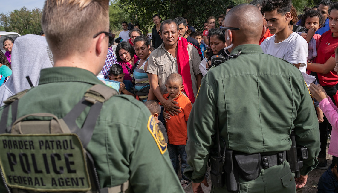 LOS EBANOS, TEXAS - JULY 02: U.S. Border Patrol agents watch over immigrants after taking them into custody on July 02, 2019 in Los Ebanos, Texas. (Photo by John Moore/Getty Images)