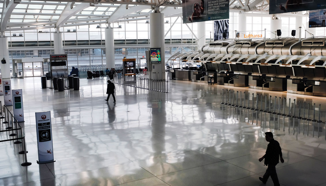 NEW YORK, NEW YORK - MARCH 07: People walk through a sparse international departure terminal at John F. Kennedy Airport (JFK) as concern over the coronavirus grows on March 7, 2020 in New York City.  (Photo by Spencer Platt/Getty Images)