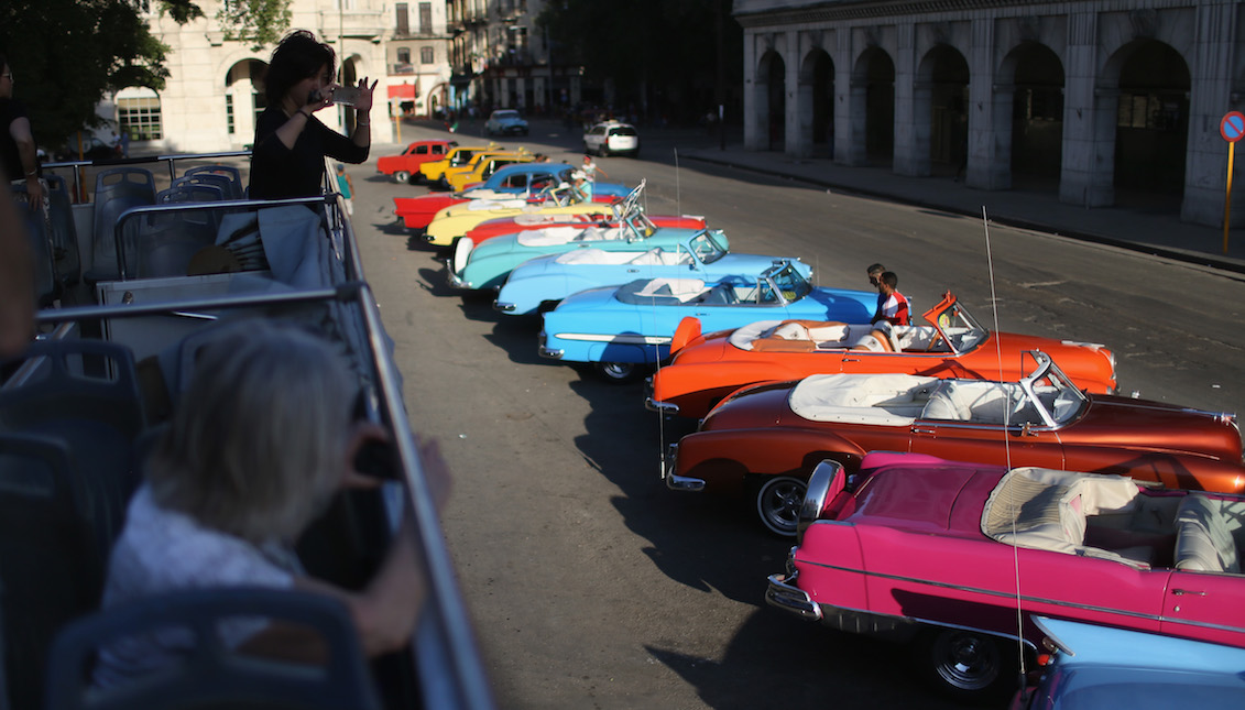 HAVANA, CUBA - FEBRUARY 28: Tourists take in the sites from a double-decker tour bus of Havana a day after the second round of diplomatic talks between the United States and Cuban officials took place in Washington, DC on February 28, 2015, in Havana, Cuba. (Photo by Joe Raedle/Getty Images)