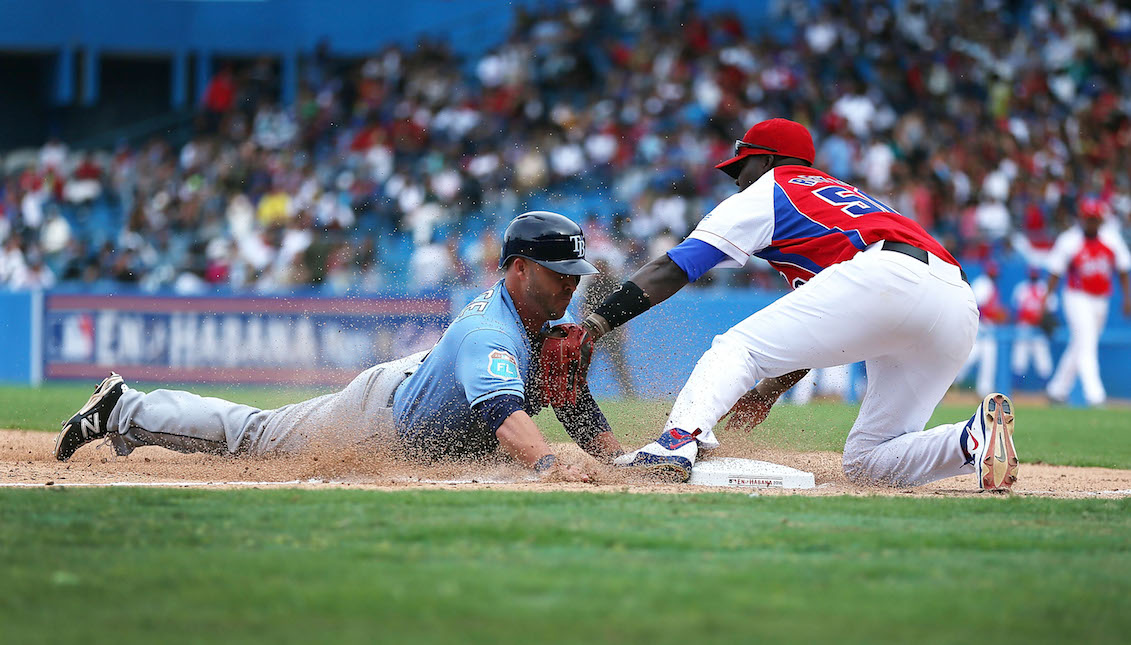 HAVANA, CUBA - MARCH 22: Tampa Bay Rays Steve Pearce dives safely into third base during the exposition game between the Cuban national team and the Tampa Bay Rays of the Major League Baseball at the Estado Latinoamericano March 22, 2016 in Havana, Cuba. U.S. President Barack Obama attended the game after becoming the first sitting president to visit Cuba in 88 years. (Photo by Joe Raedle/Getty Images)