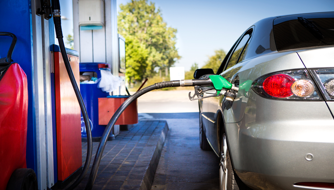 Vehicle loading gasoline at service station.