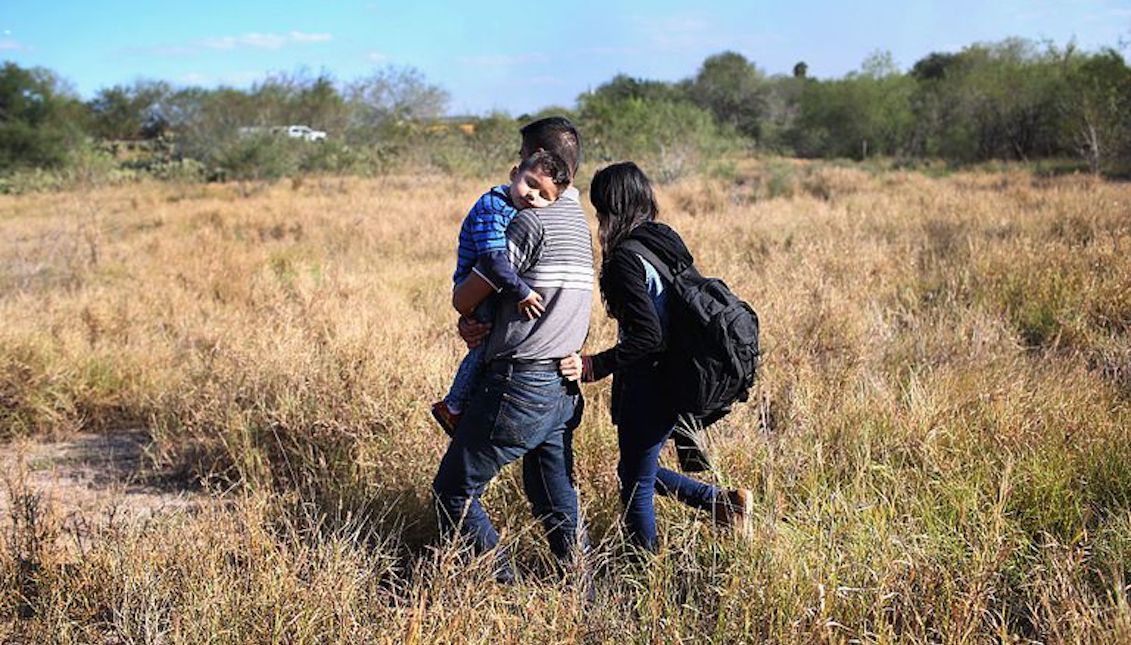 A father carries his sleeping son, 3, after their family illegally crossed the U.S.-Mexico border on December 7, 2015 near Rio Grande City, Texas. John Moore / Getty Images