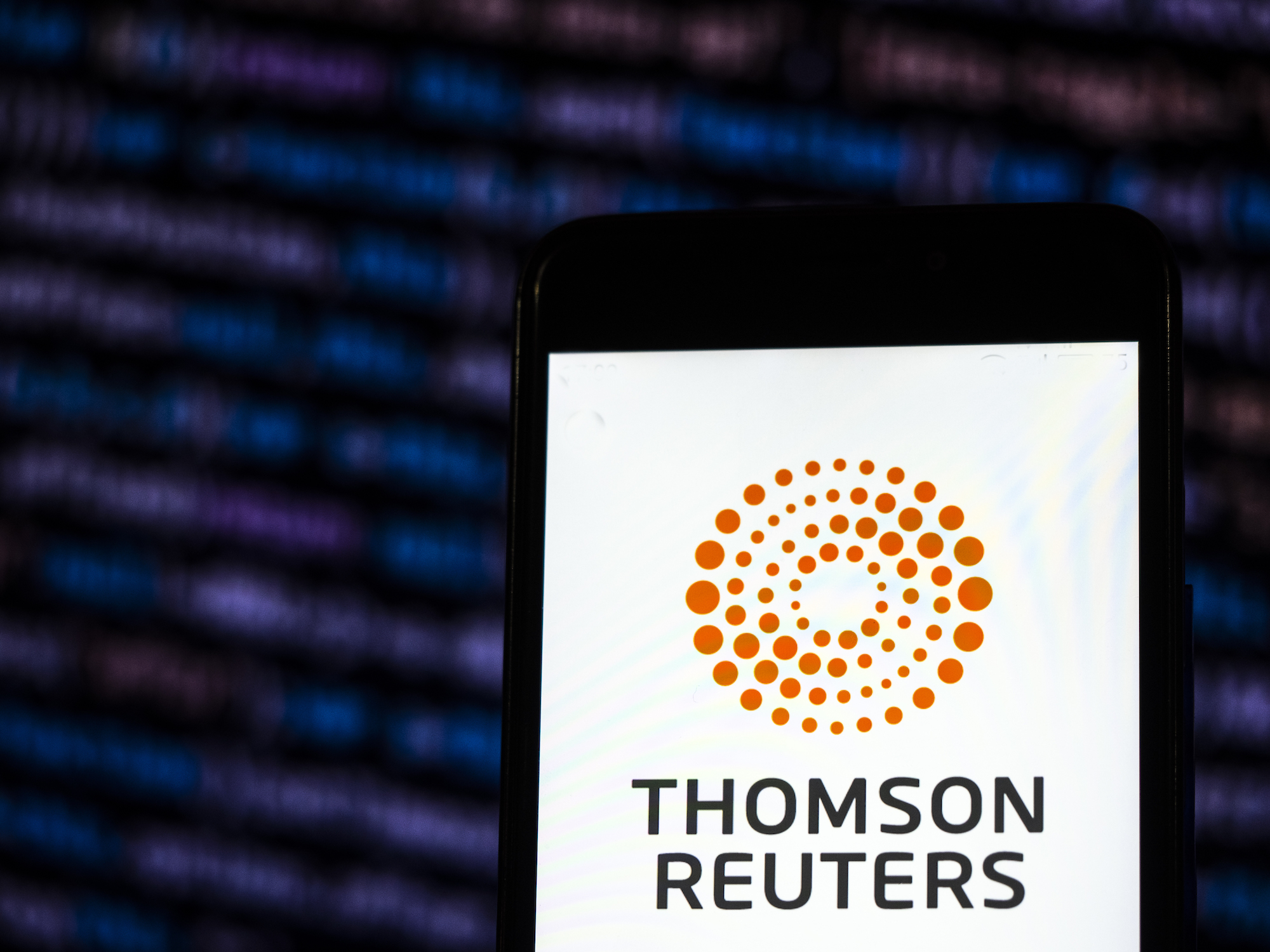 In this photo illustration, the Thomson Reuters Corporation Mass media company logo is seen displayed on a smartphone. Photo illustration: Igor Golovniov/SOPA Images/LightRocket via Getty Images.
