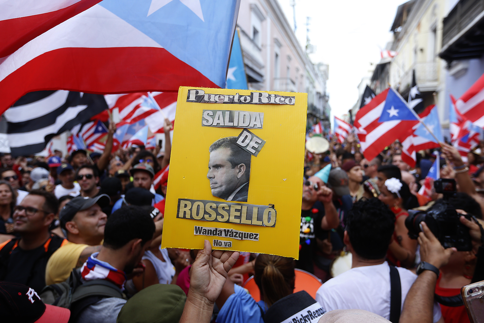 People celebrate together after the 5pm hour which was when Ricardo Rossello, the Governor of Puerto Rico, agreed to step down from power on August 2, 2019 in Old San Juan, Puerto Rico. The Governor agreed to step down after protesters spent days asking for the resignation of Gov. Rosselló after a group chat was exposed that included misogynistic and homophobic comments. (Photo by Jose Jimenez/Getty Images) 