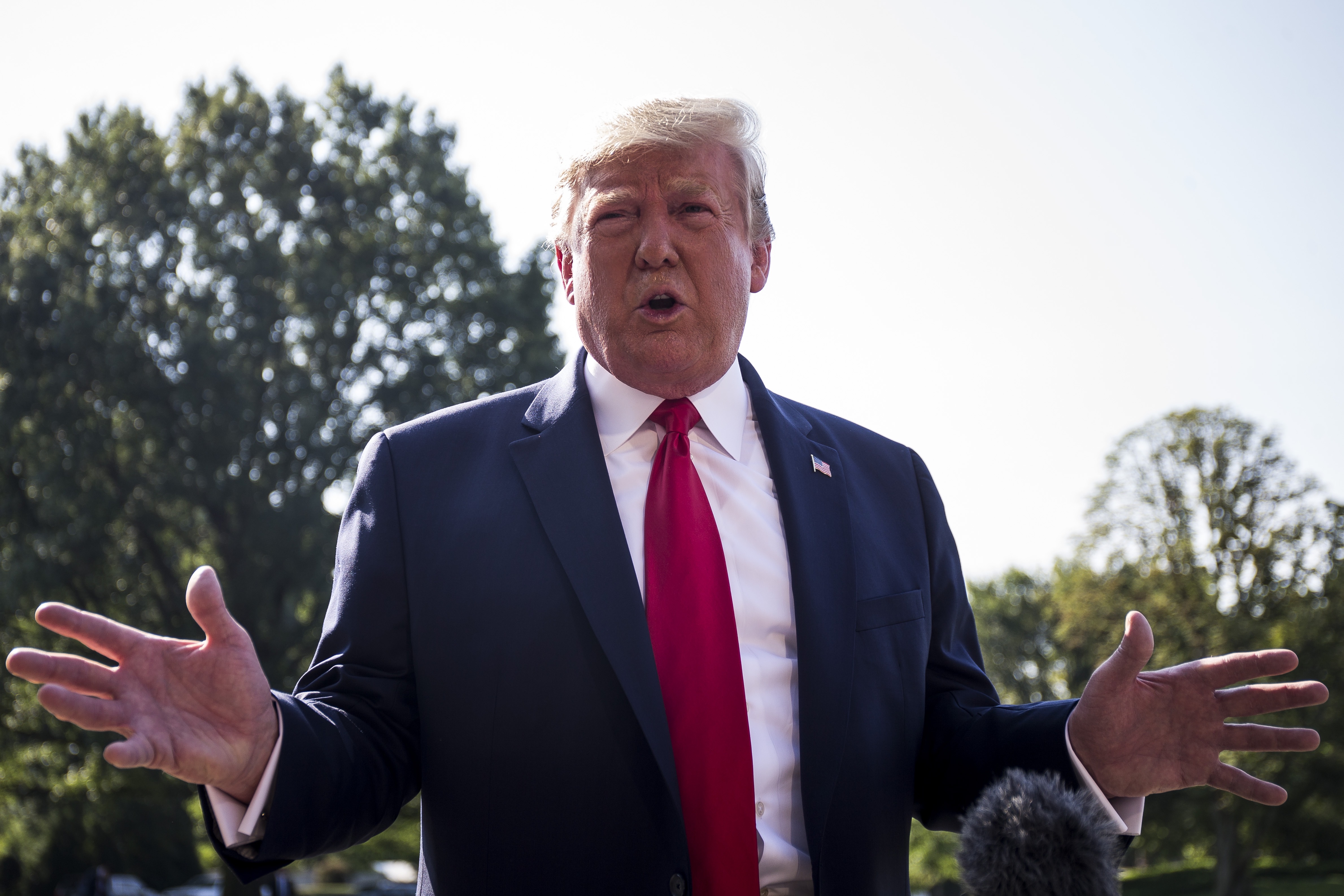 President Donald Trump speaks to members of the press before departing from the White House en route to Dayton, Ohio and El Paso, Texas on August 7, 2019, in Washington, DC. Photo by Zach Gibson/Getty Images