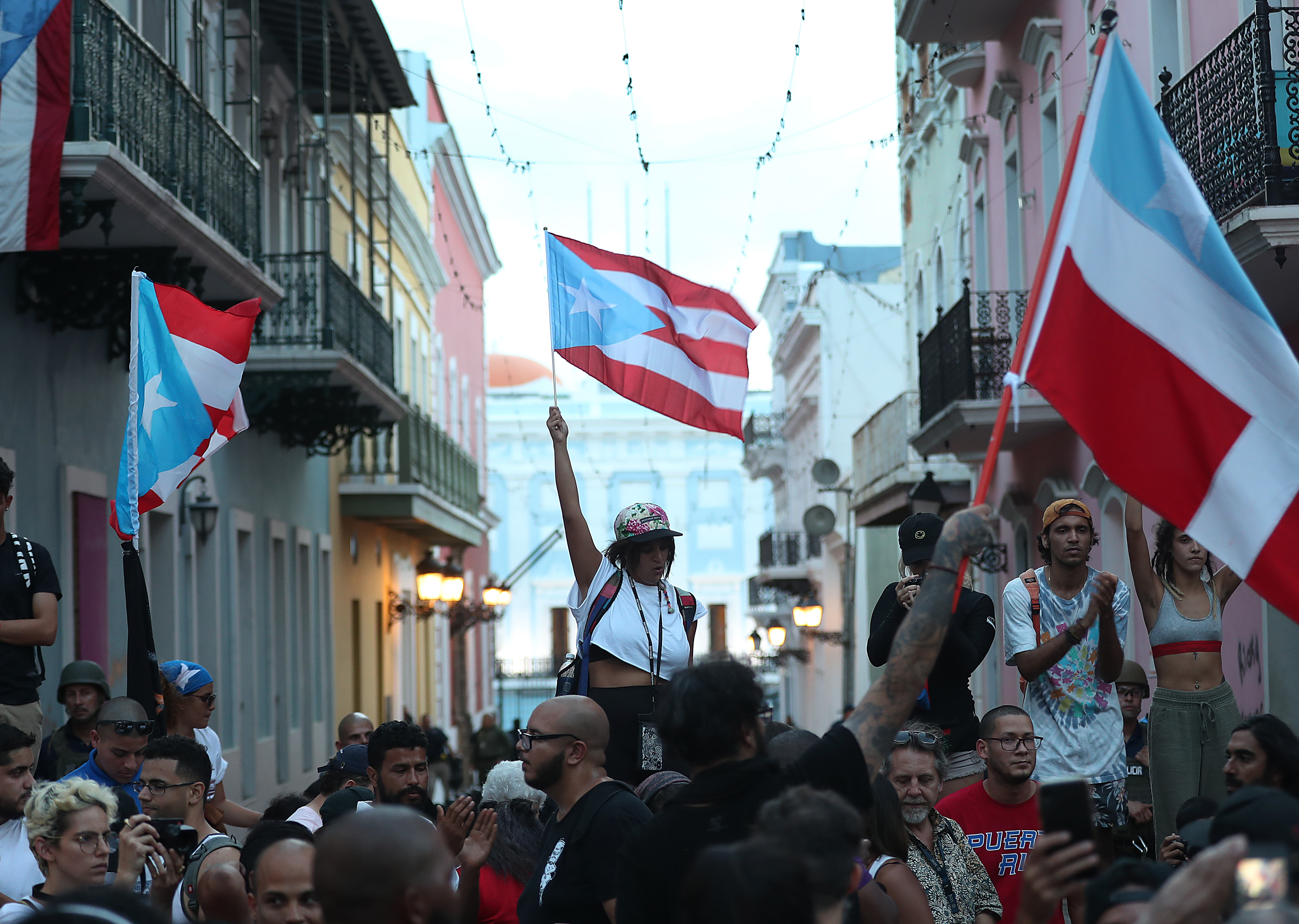 SAN JUAN, PUERTO RICO - JULY 16: Protesters demonstrate along a street leading to the Governors mansion as they call for Puerto Rican Governor Ricardo Rosselló to step down on July 16, 2019 in Old San Juan, Puerto Rico. The protesters are asking the governor to leave office after remarks that include derogatory terms against women and homophobic comments targeting singer Ricky Martin were leaked to the media from a private group chat. (Photo by Joe Raedle/Getty Images)