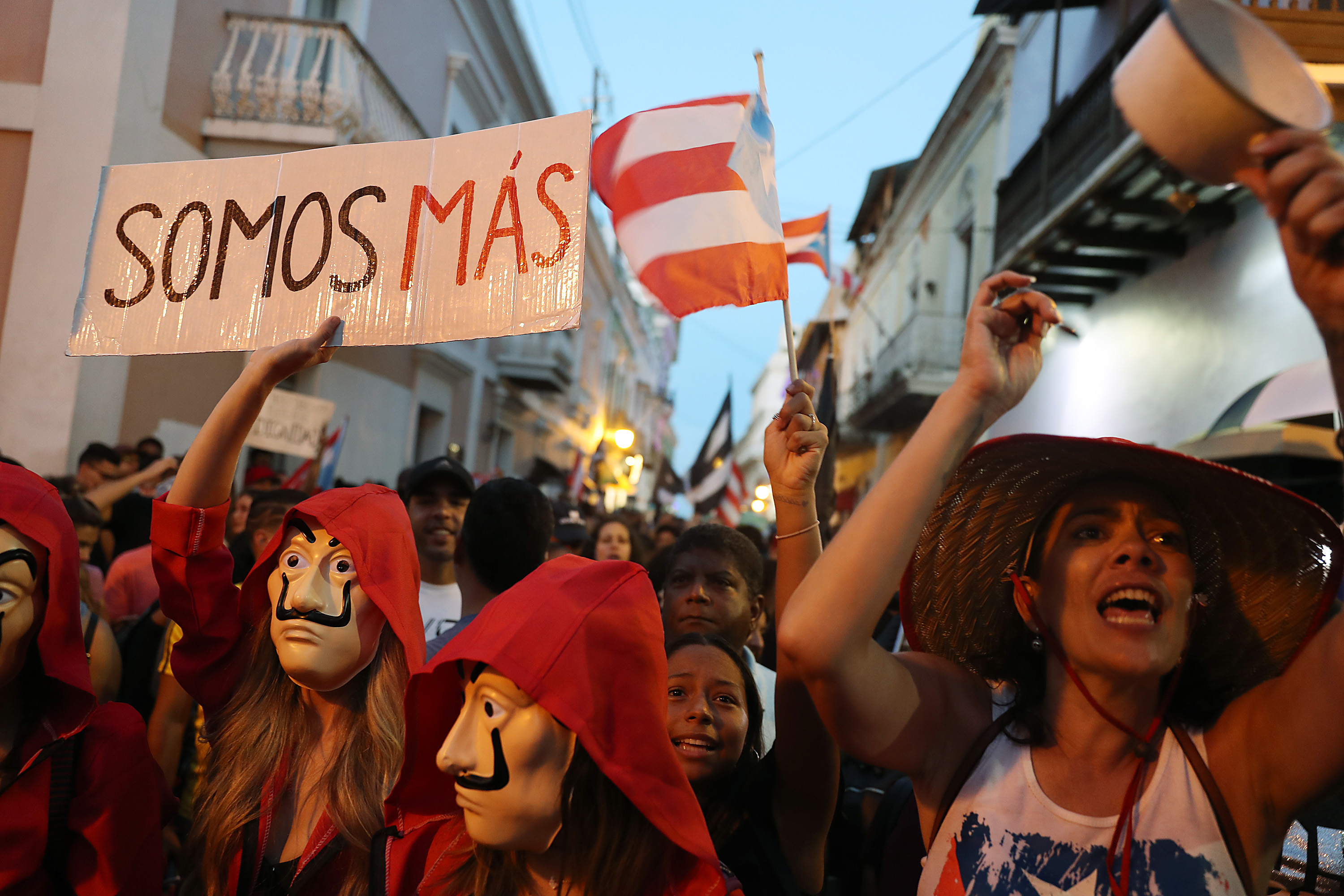 People celebrate together after the 5pm hour which was when Ricardo Rossello, the Governor of Puerto Rico, agreed to step down from power on August 2, 2019 in Old San Juan, Puerto Rico. Joe Raedle/Getty Images.