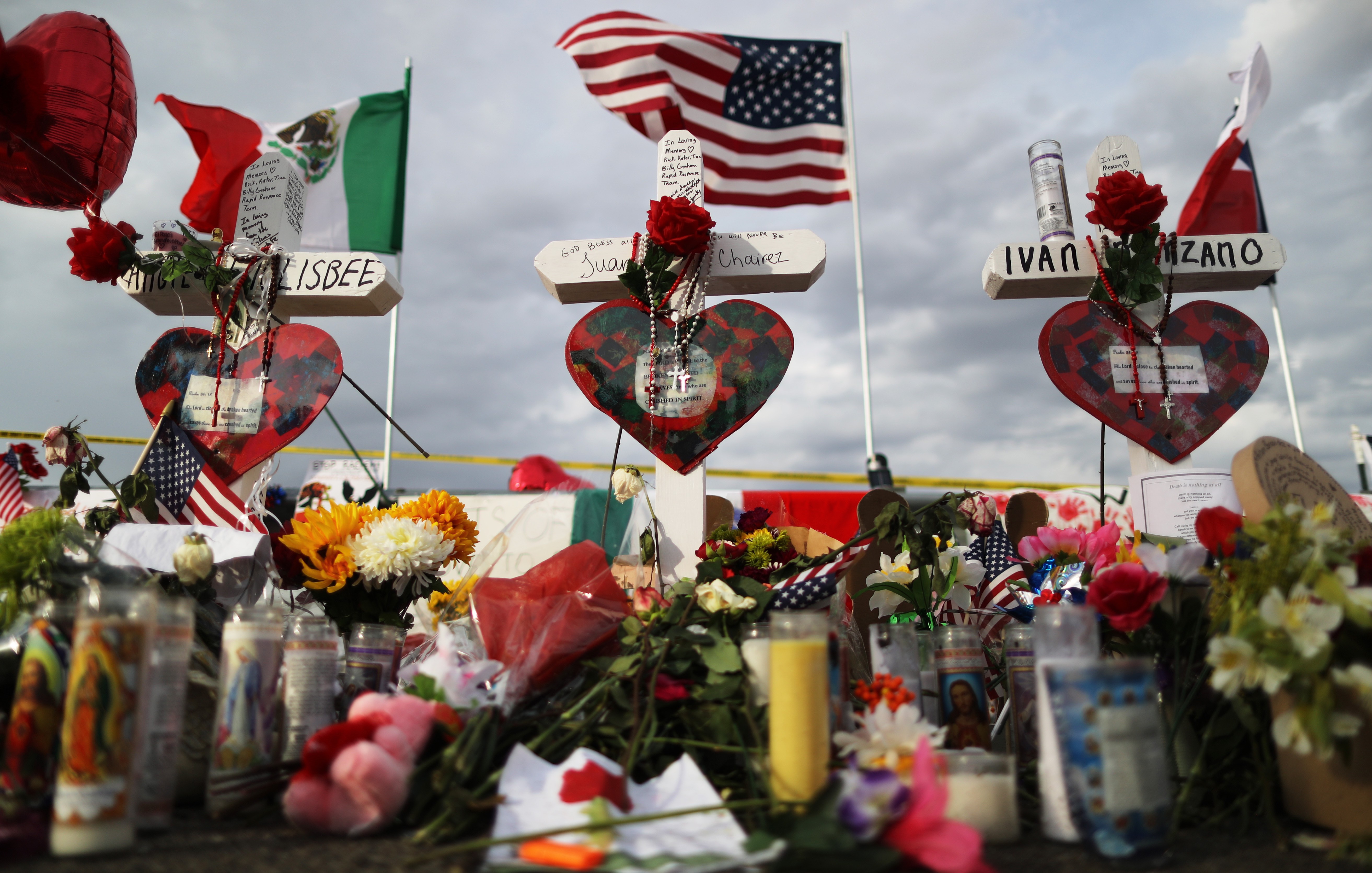 The U.S. and Mexican flags fly above a makeshift memorial for victims outside Walmart, near the scene of a mass shooting which left at least 22 people dead, on August 6, 2019, in El Paso, Texas. President Donald Trump plans to visit the city on August 7. Photo by Mario Tama/Getty Images