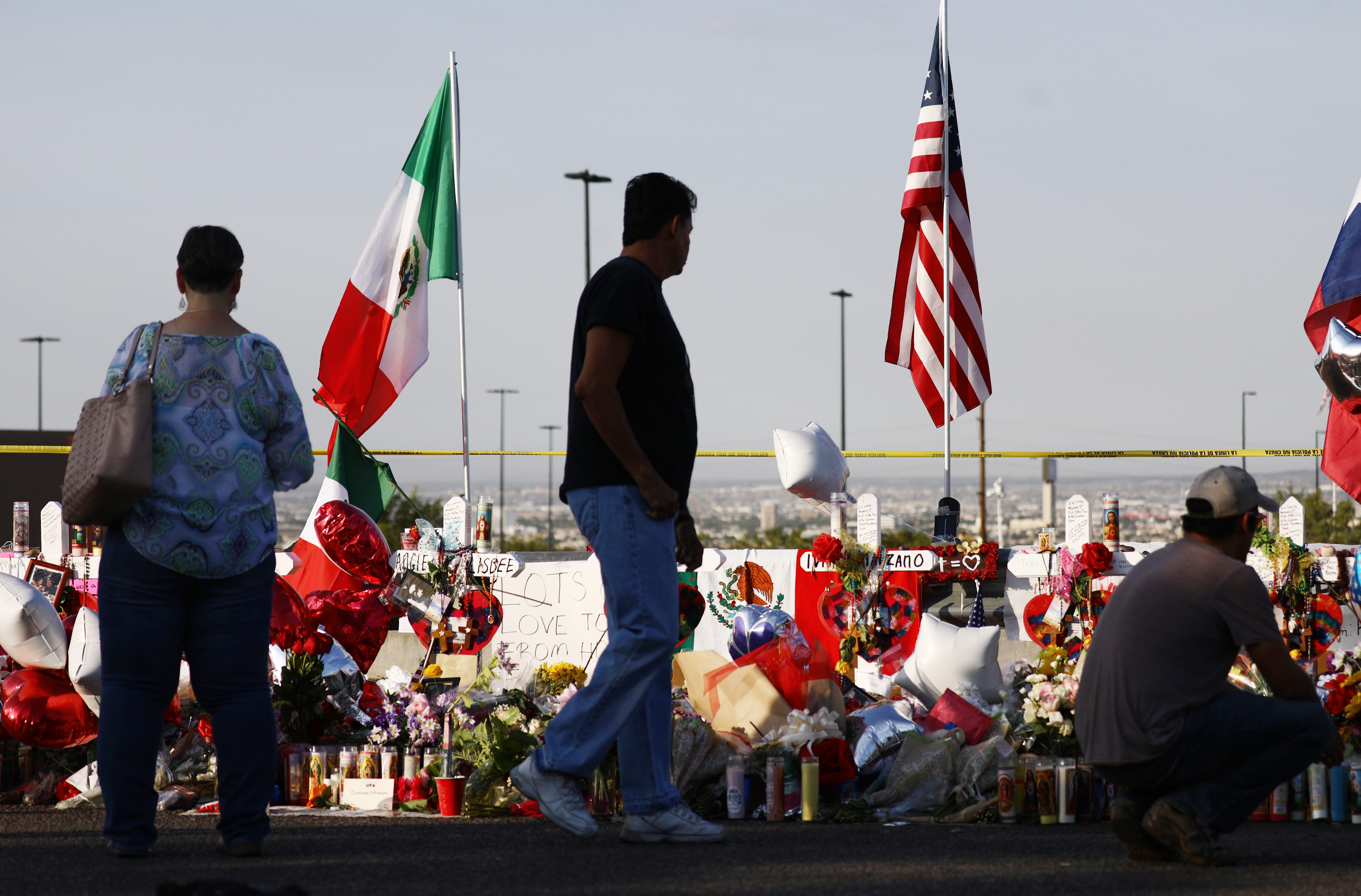 The Mexican and U.S. flags fly at a makeshift memorial honoring victims outside Walmart, near the scene of a mass shooting which left at least 22 people dead, on August 7, 2019, in El Paso, Texas. Photo by Mario Tama/Getty Images