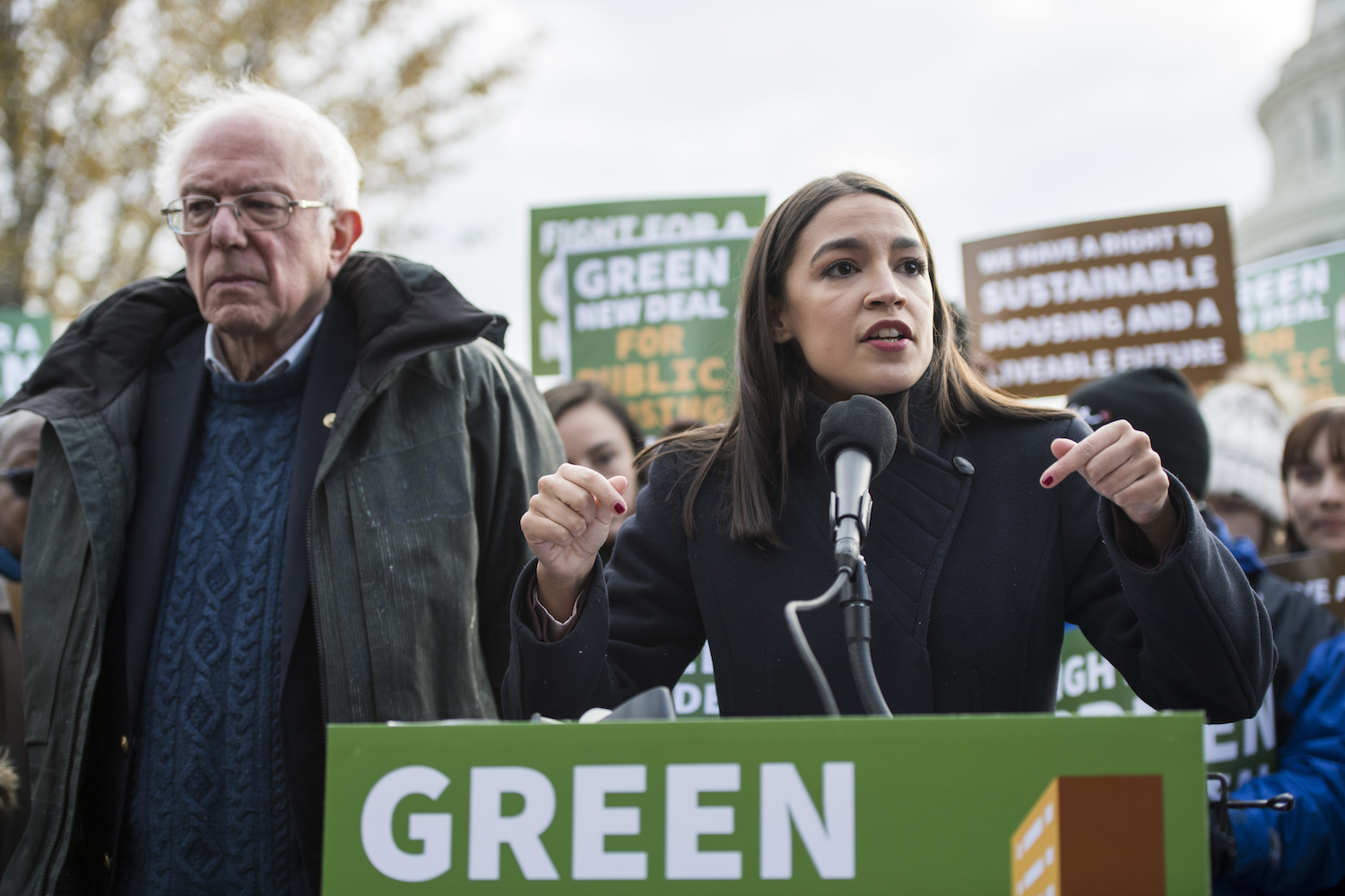 Rep. Alexandria Ocasio-Cortez, D-N.Y. and Sen. Bernie Sanders, D-Vt., along with affordable housing advocates and climate change activists announce the introduction of public housing legislation as part of the Green New Deal outside the Capitol on Nov. 14, 2019. Bill Clark / CQ-Roll Call, Inc via Getty Images