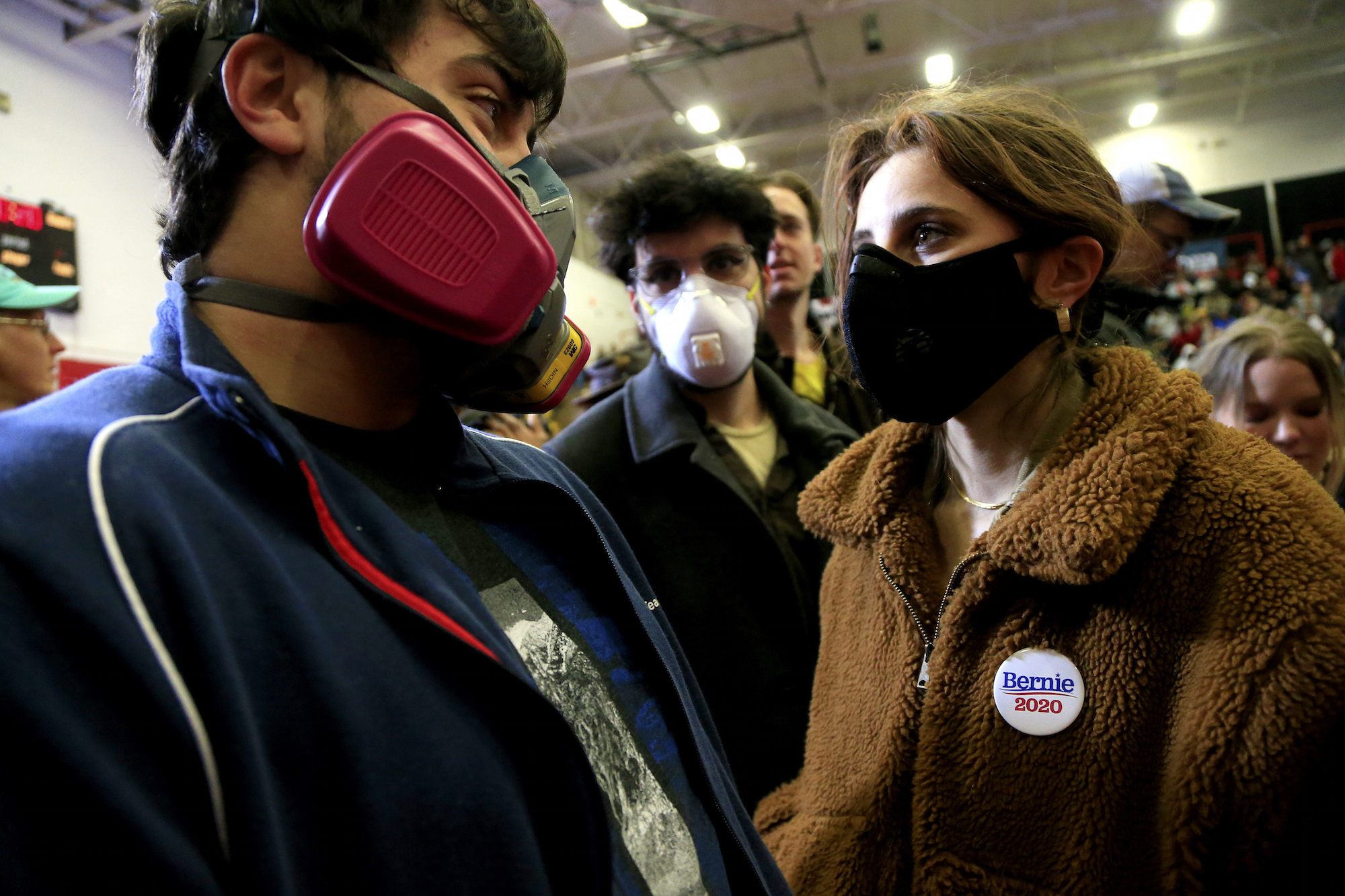 Concerned about the spread of COVID-19 in large gatherings, students from the University of North Carolina School of the Arts wear respiratory masks as they wait for Democratic presidential candidate Sen. Bernie Sanders (I-VT) to speak to supporters during a rally and march to early vote on February 27, 2020 at Winston-Salem State University in Winston-Salem, North Carolina. Photo: Brian Blanco/Getty Images.
