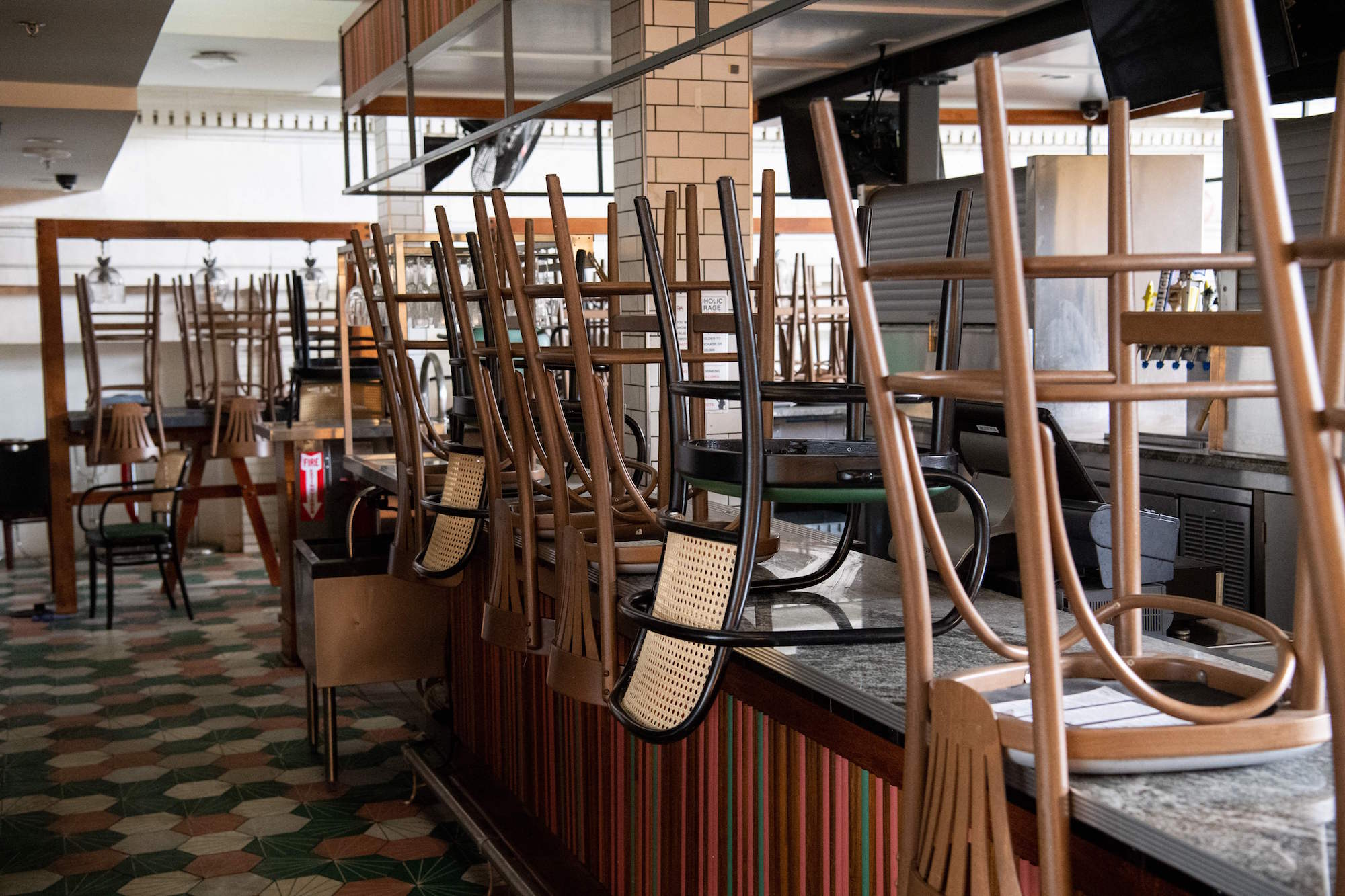 Bar stools sit on top of a counter at a closed restaurant at a mostly empty Union Station in Washington, DC, May 12, 2021. Photo: Saul Loeb/AFP via Getty Images.
