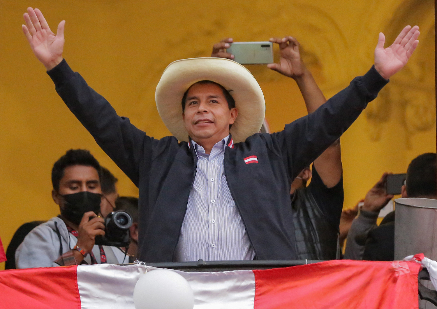 Peruvian presidential candidate Pedro Castillo gestures at supporters from a balcony of his party's headquarters in Lima on June 7, 2021. Photo: Luka Gonzalez/AFP via Getty Images
