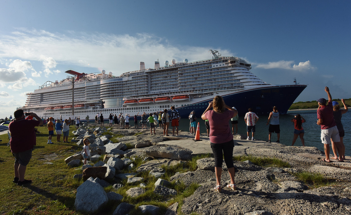 People come out to watch the new Carnival Cruise Line ship Mardi Gras as it departs on its maiden voyage, a seven-day cruise to the Caribbean from Port Canaveral, Florida on July 31, 2021. Photo: Paul Hennessy/Anadolu Agency via Getty Images.