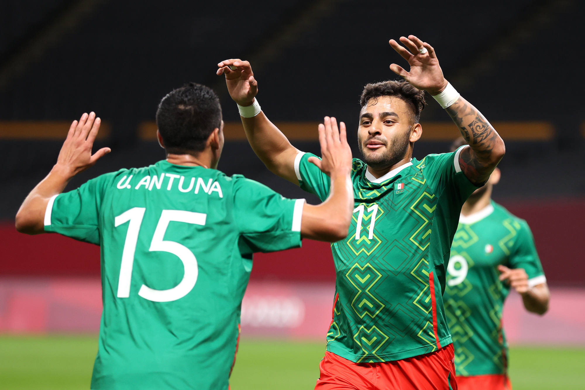 Alexis Vega #11 of Team Mexico celebrates with Uriel Antuna #15 after scoring their side's first goal during the Men's First Round Group A match between South Africa and Mexico on day five of the Tokyo 2020 Olympic Games at Sapporo Dome on July 28, 2021 in Sapporo, Hokkaido, Japan. Photo: Masashi Hara/Getty Images.
