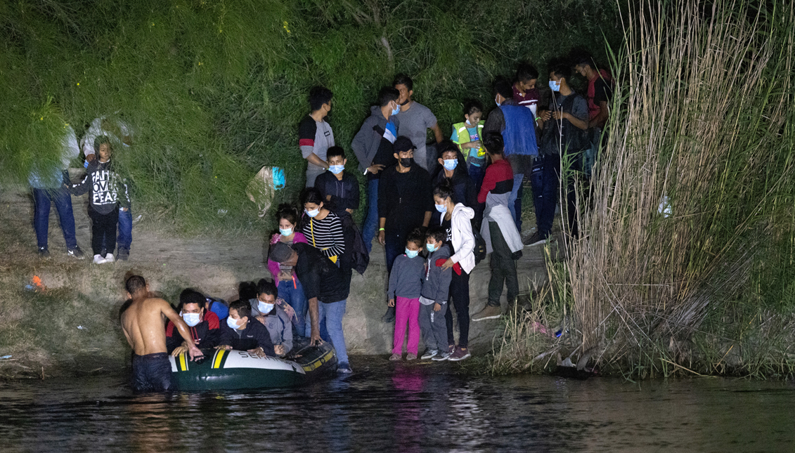 Immigrants prepare to cross the Rio Grande into Texas on August 14, 2021 in Roma, Texas. Recent U.S. Customs and Border Protection figures show more than 200,000 people were apprehended at the border in July, the highest number in 21 years. More than 82,000 of those were family members traveling together.   John Moore/Getty Images