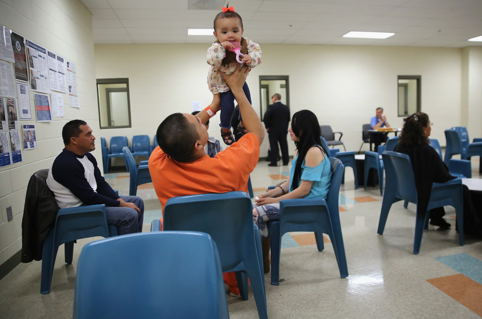 ADELANTO, CA - NOVEMBER 15: An immigrant detainee holds his daughter during a family visitation visit at the Adelanto Detention Facility on November 15, 2013 in Adelanto, California. The facility, the largest and newest Immigration and Customs Enforcement (ICE), detention center in California, houses an average of 1,100 immigrants in custody pending a decision in their immigration cases or awaiting deportation.  (Photo by John Moore/Getty Images)