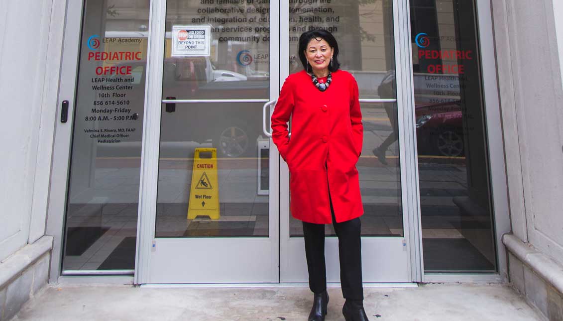  Dr. Bonilla-Santiago in front of a building on the LEAP Academy campus that bears her name in her honor. Photo: Samantha Laub / AL DÍA News