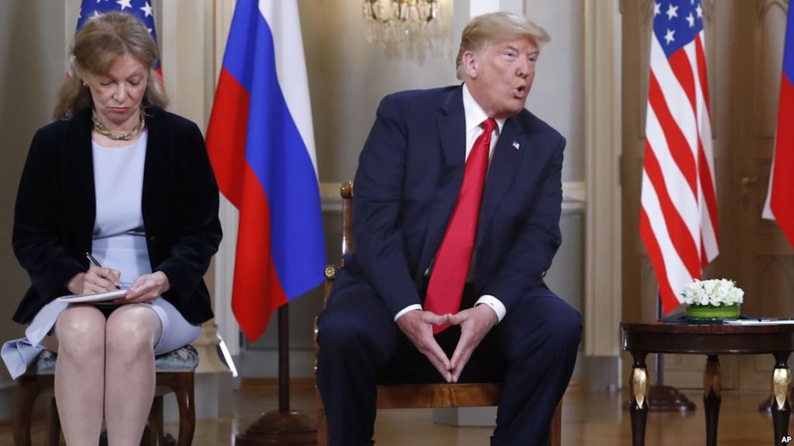 In the photo: the interpreter Marina Gross, takes note when the president of the United States, Donald Trump, speaks with Russian President Vladimir Putin at the beginning of their personal meeting at the Presidential Palace in Helsinki, Finland. Source: https://www.voanews.com/